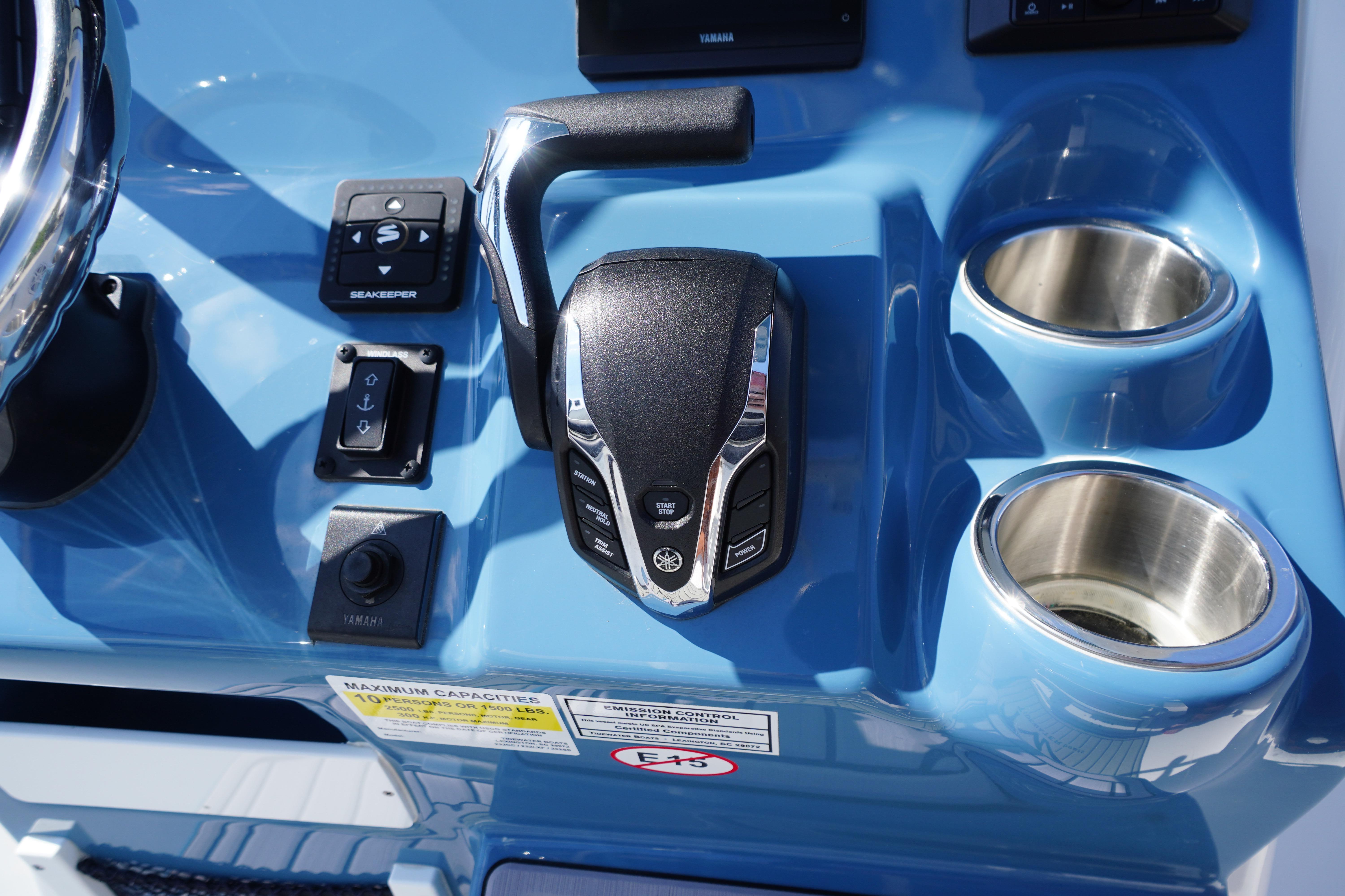 Control panel of 2025 Tidewater 232 SS boat with throttle and cup holders.