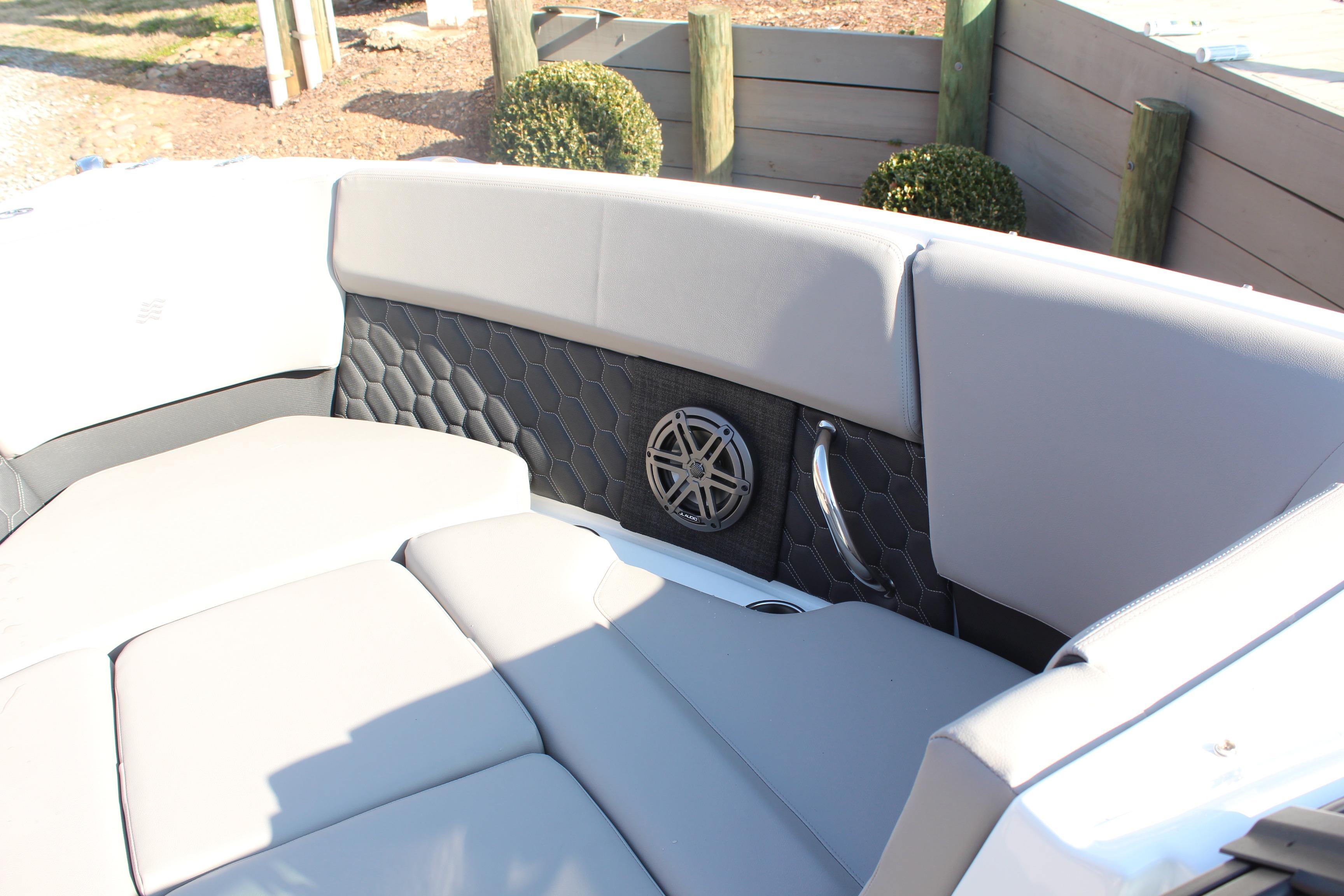 Interior of 2026 Four Winns H4 boat with gray seating and speaker detail.