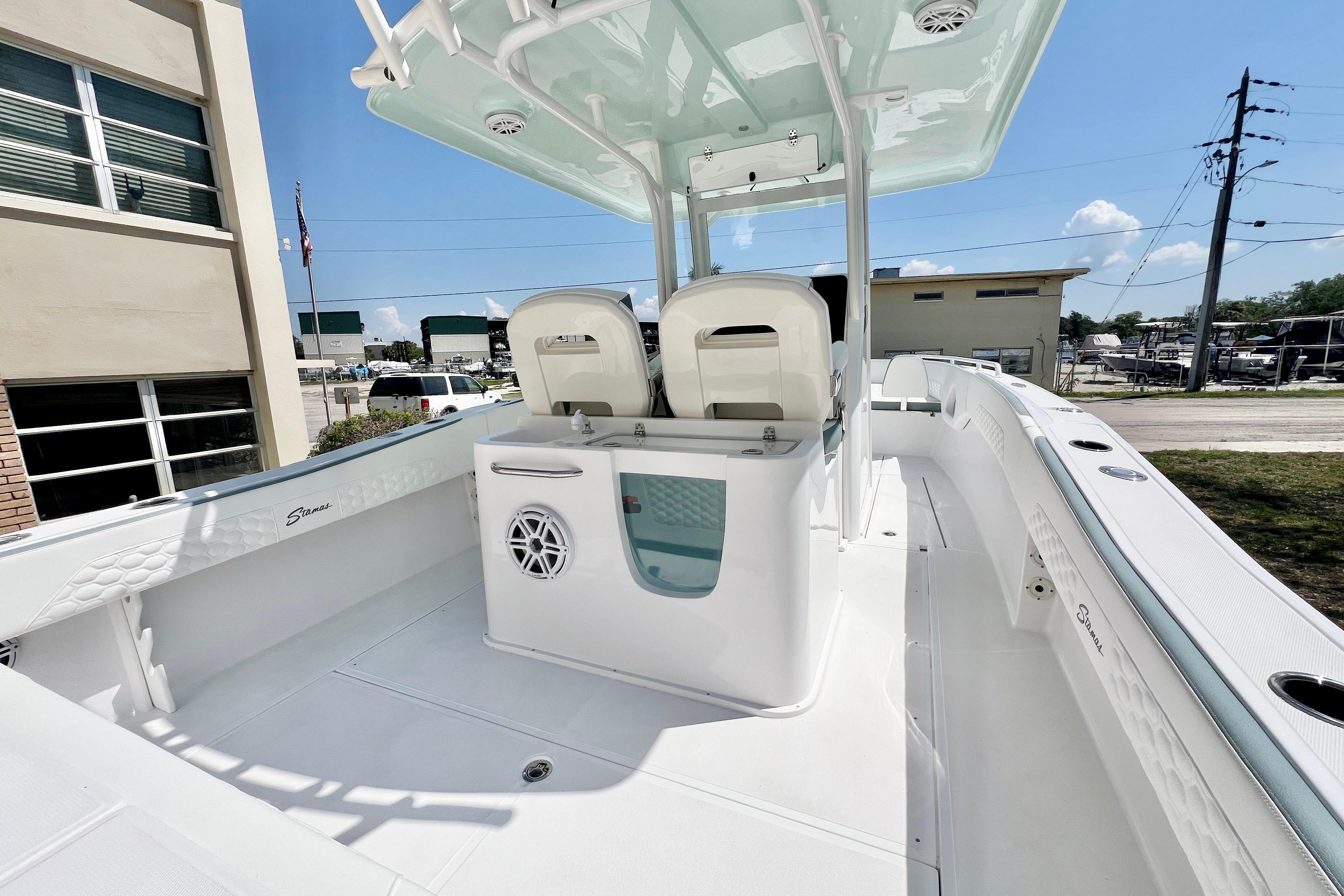2026 Stamas 31T Aventura boat interior with seating and helm, docked outdoors.