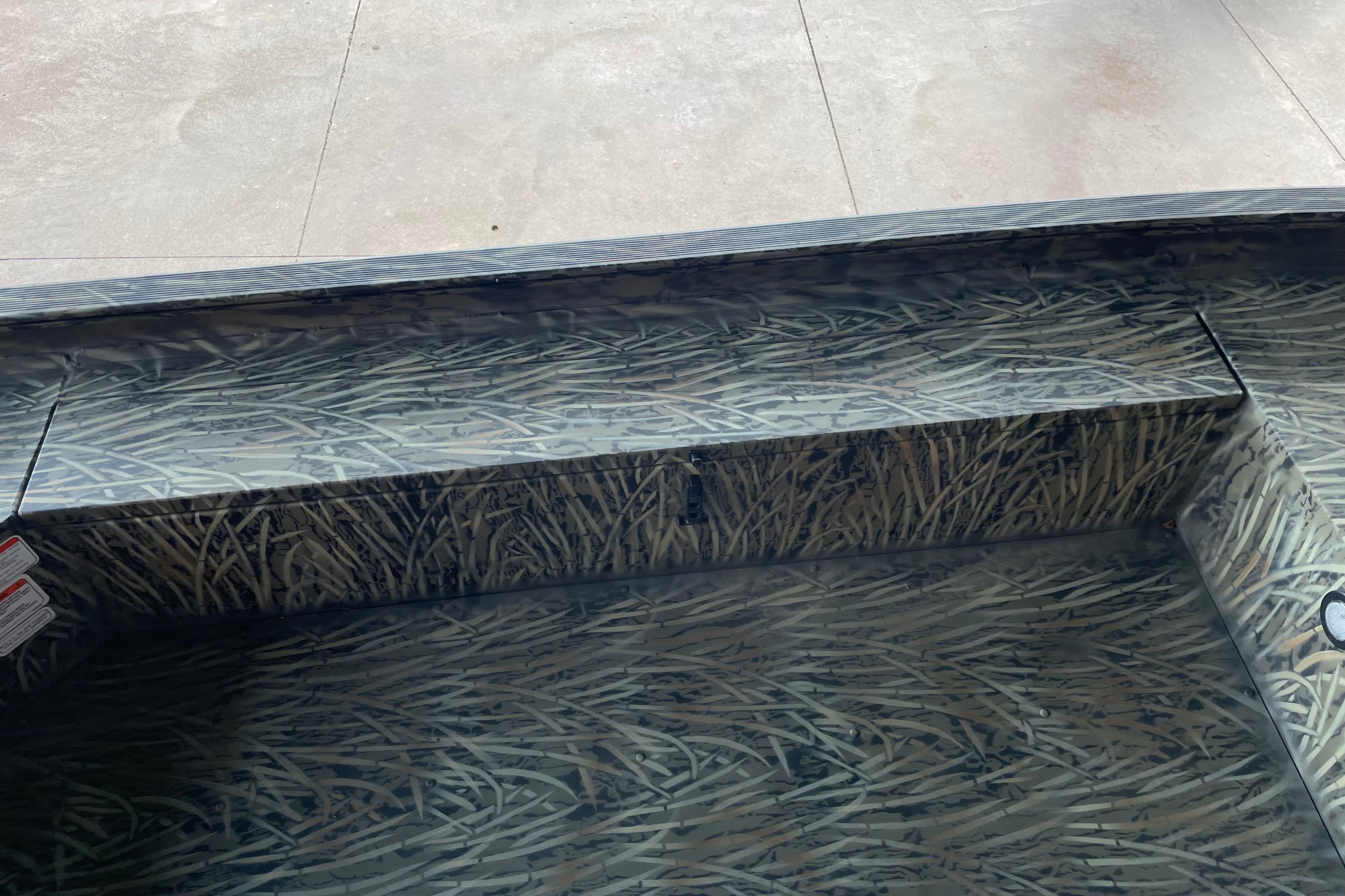 2026 Tracker Grizzly 1654 T Sportsman boat interior with camouflage pattern.