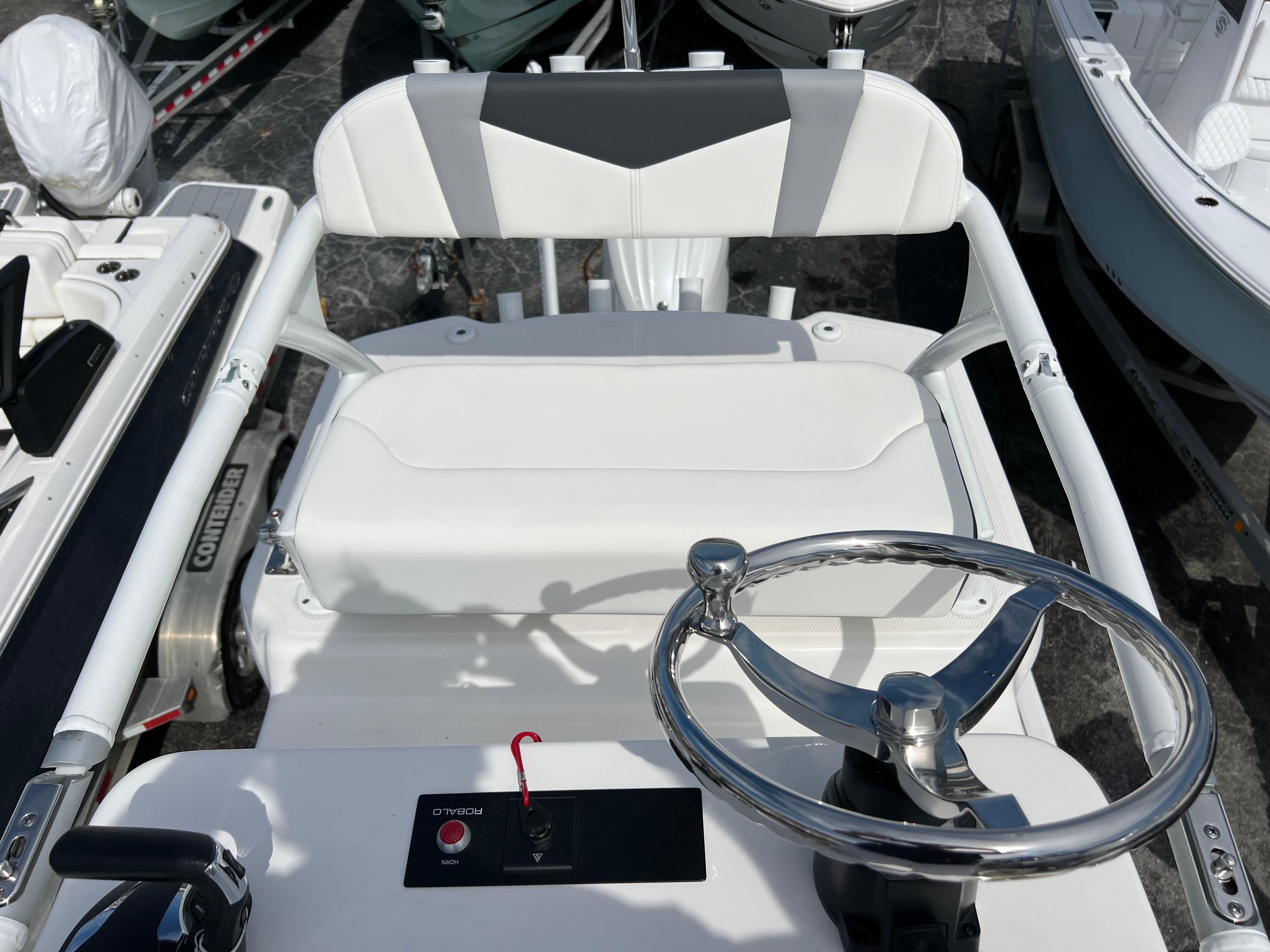 2024 Robalo 246 Sky Deck boat helm with steering wheel and control panel.