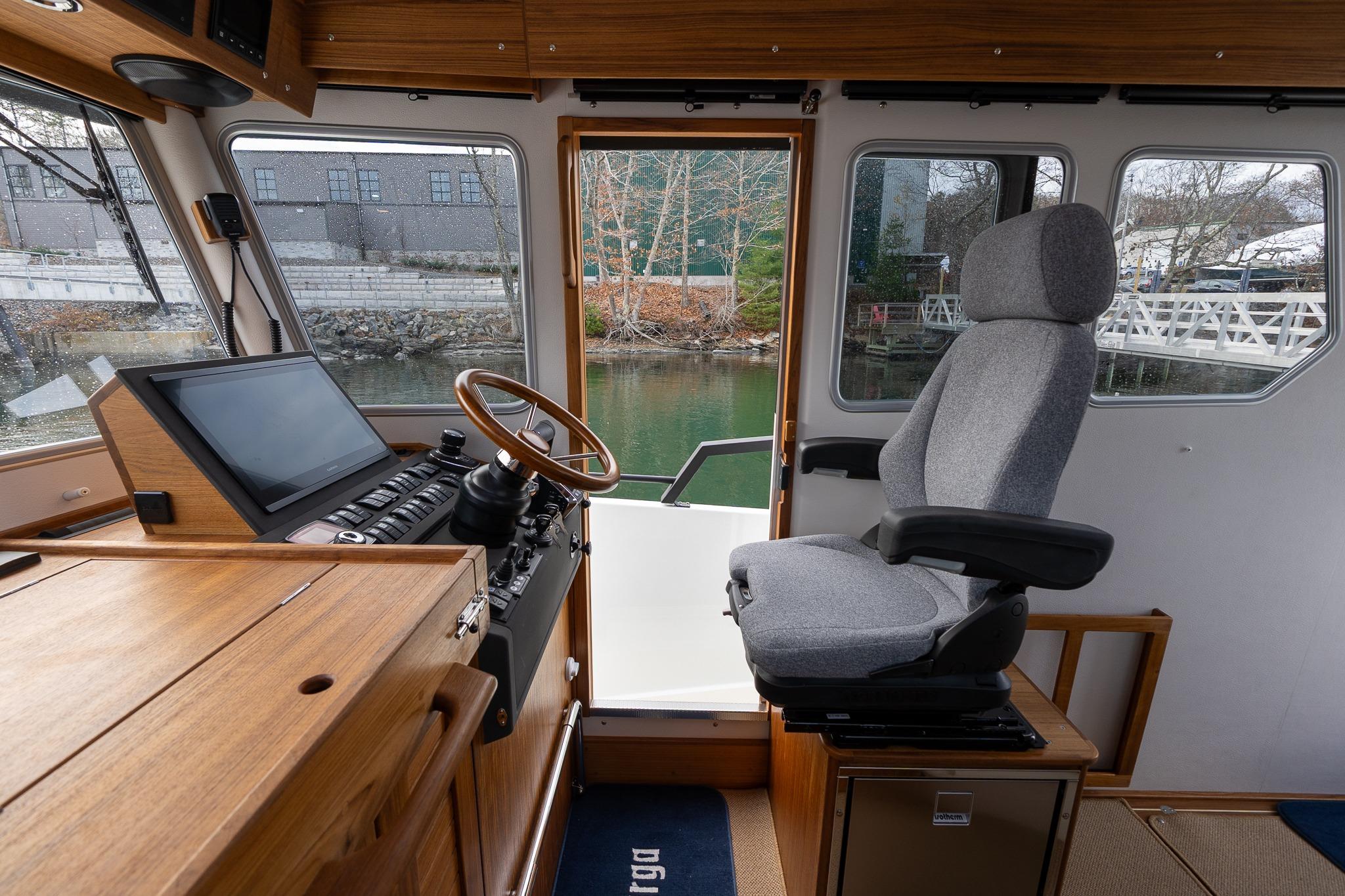 Interior of 2026 Targa 27.2 boat, featuring helm station and comfortable seating.