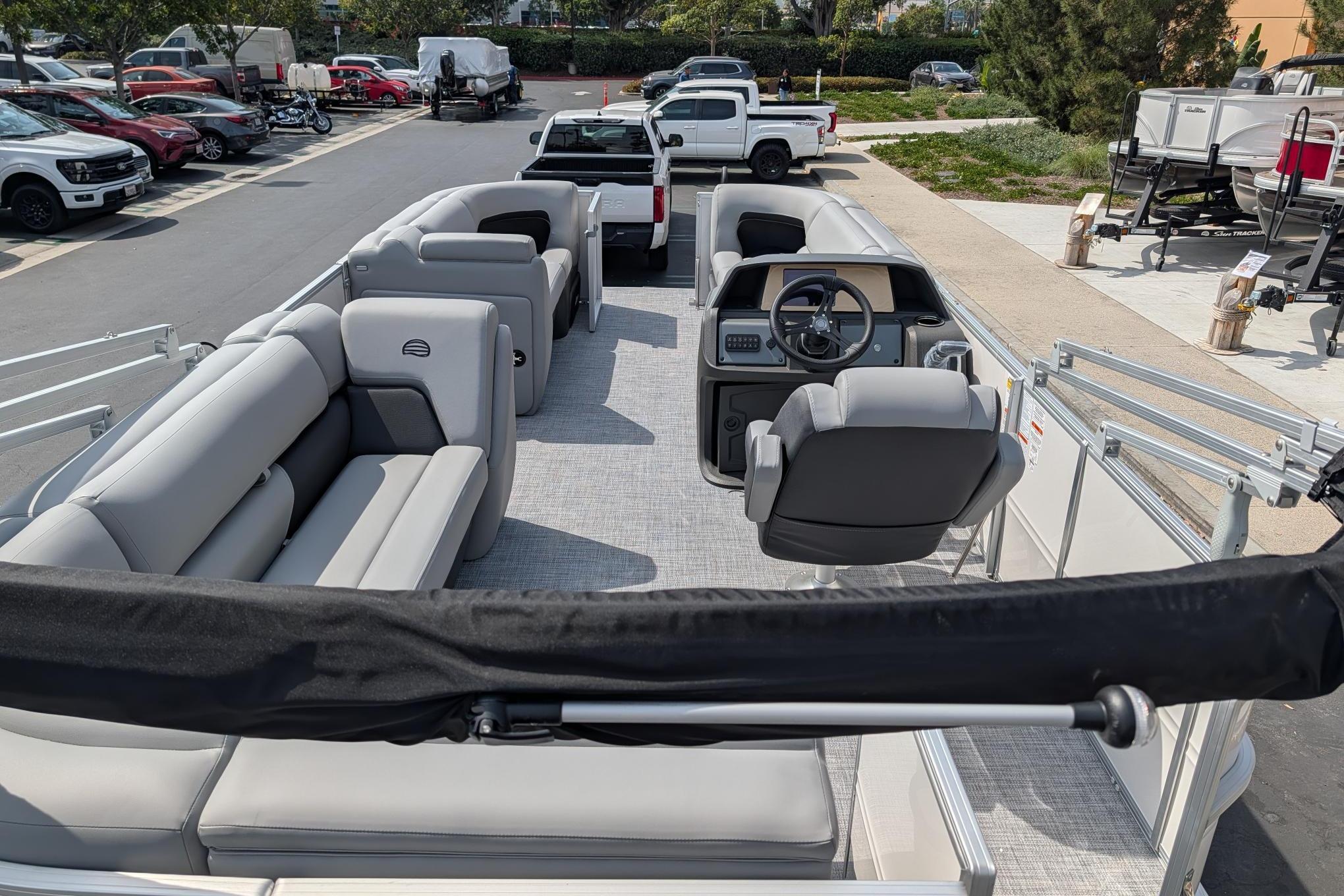 2026 Sun Tracker Party Barge 20 DLX pontoon boat with spacious seating and modern helm.