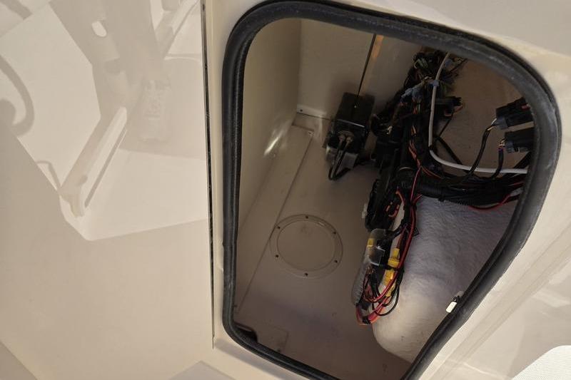 2026 Grady-White Fisherman 180 boat compartment with wiring and equipment.