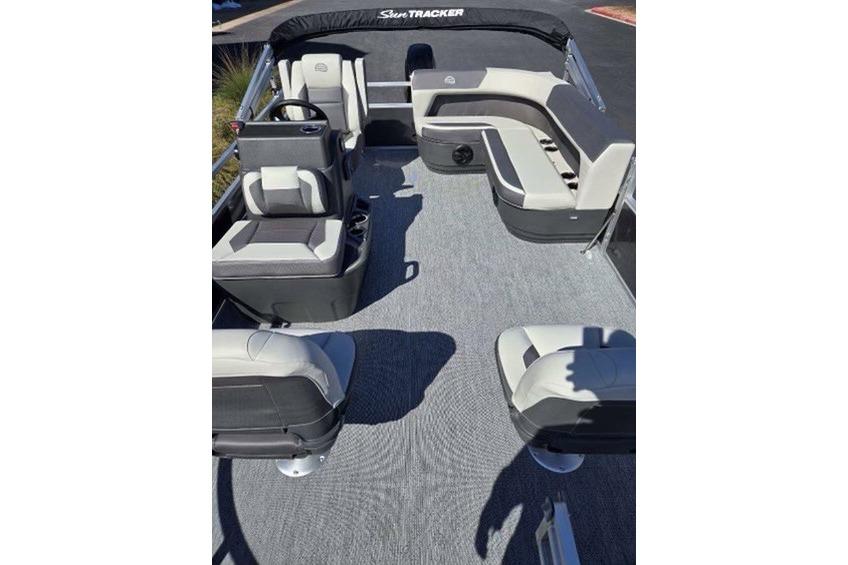 2026 Sun Tracker Bass Buggy 16 XL Select pontoon boat interior with seating and steering console.