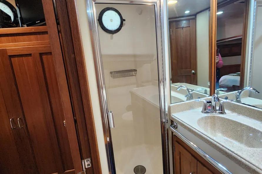 Bathroom interior of a 2006 American Tug AT, featuring a shower and sink.