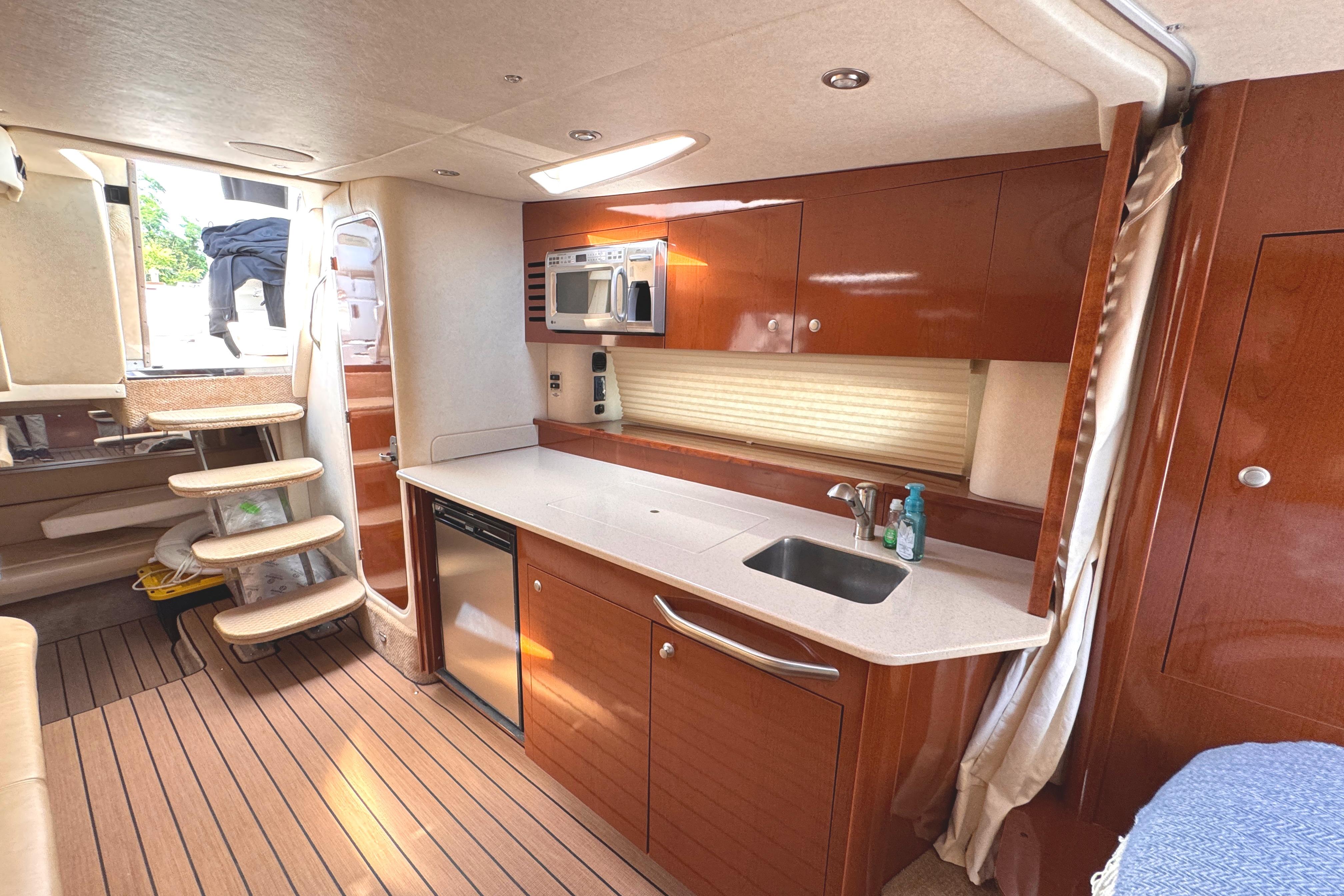 Luxurious 2008 Sea Ray Sundancer 350 yacht interior with modern kitchen and wooden flooring.
