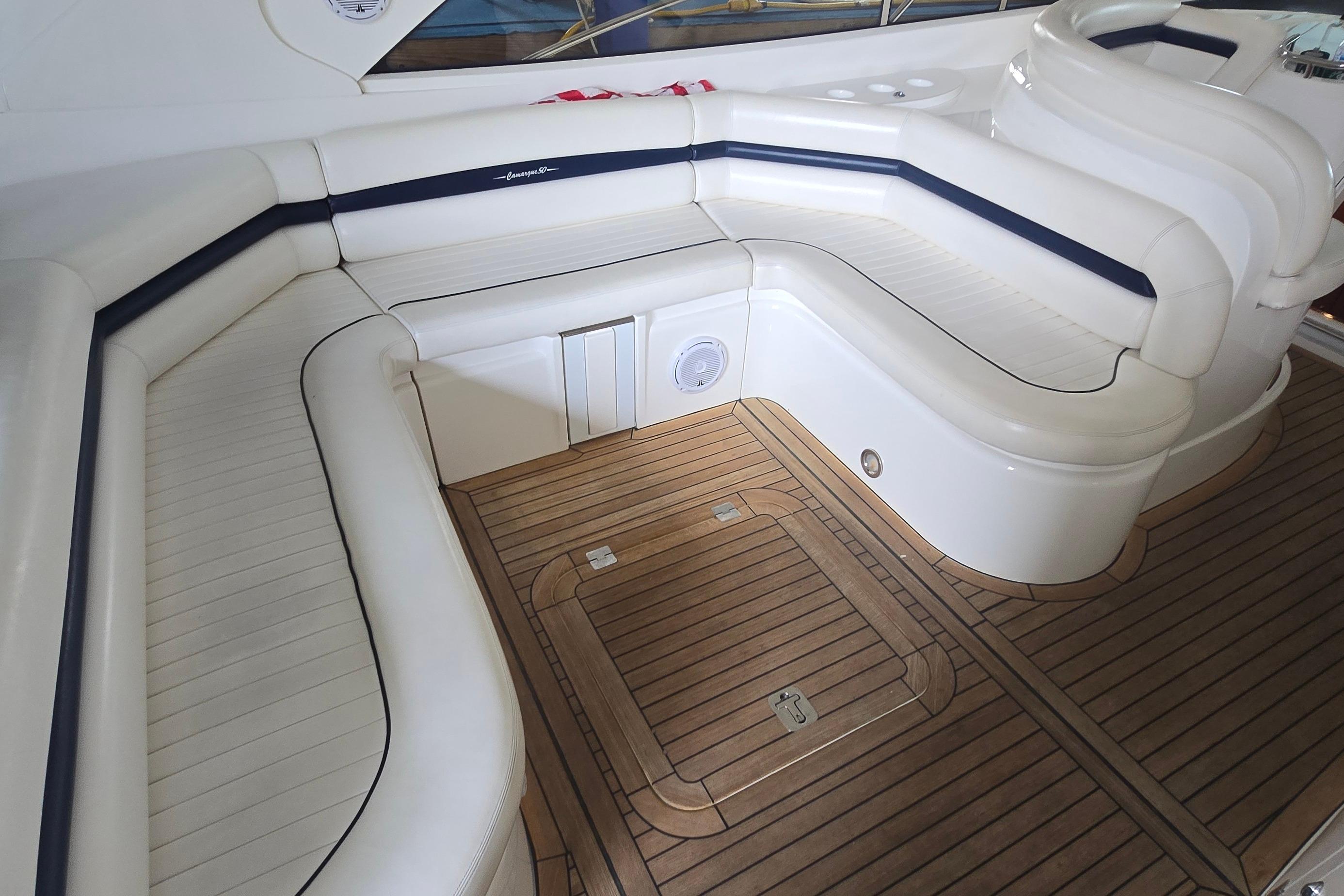 Luxurious seating area on 2004 Sunseeker Camargue 50 yacht with teak flooring.