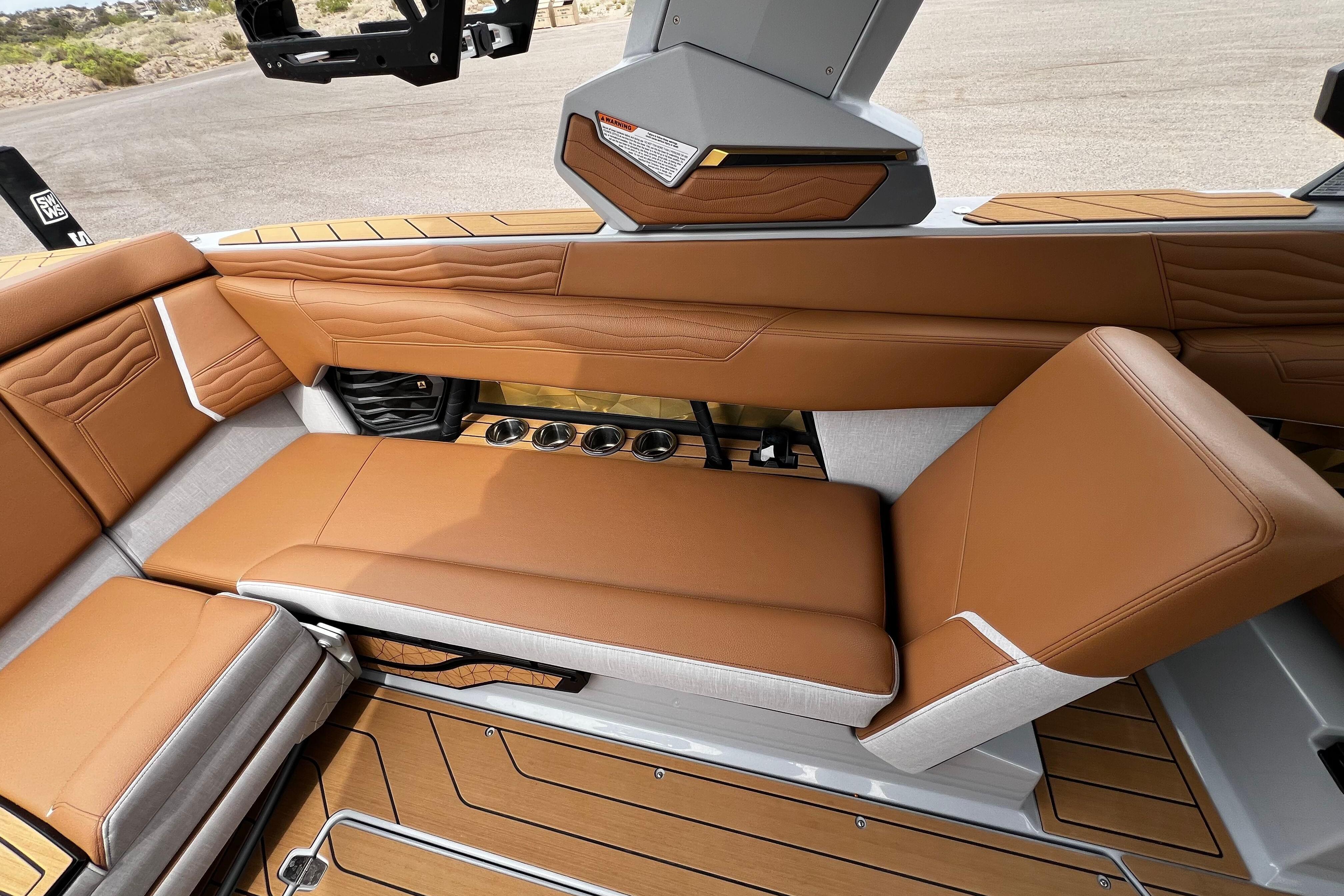 2026 Nautique Super Air Nautique G25 interior with tan leather seating and cup holders.
