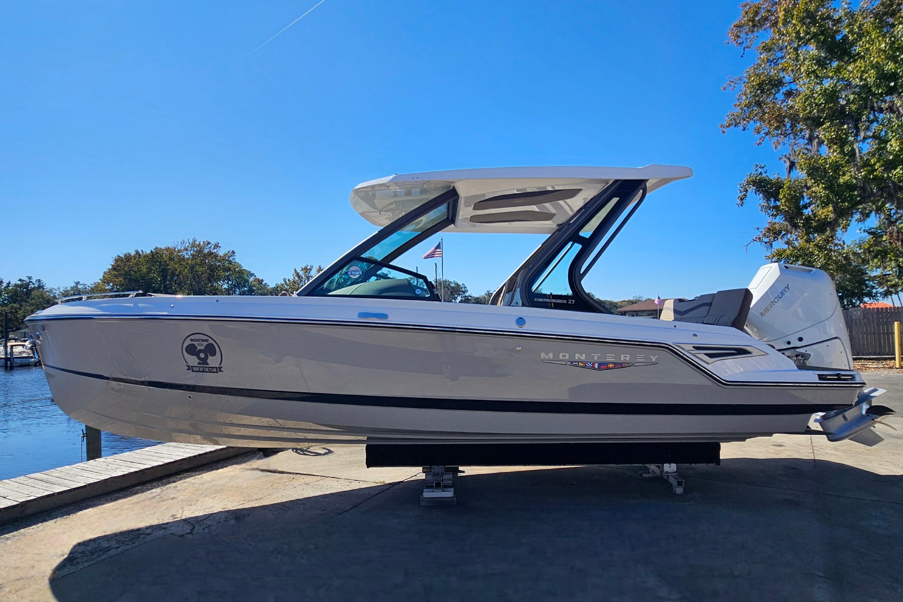 2026 Monterey Elite 27 OB boat docked under clear blue sky.