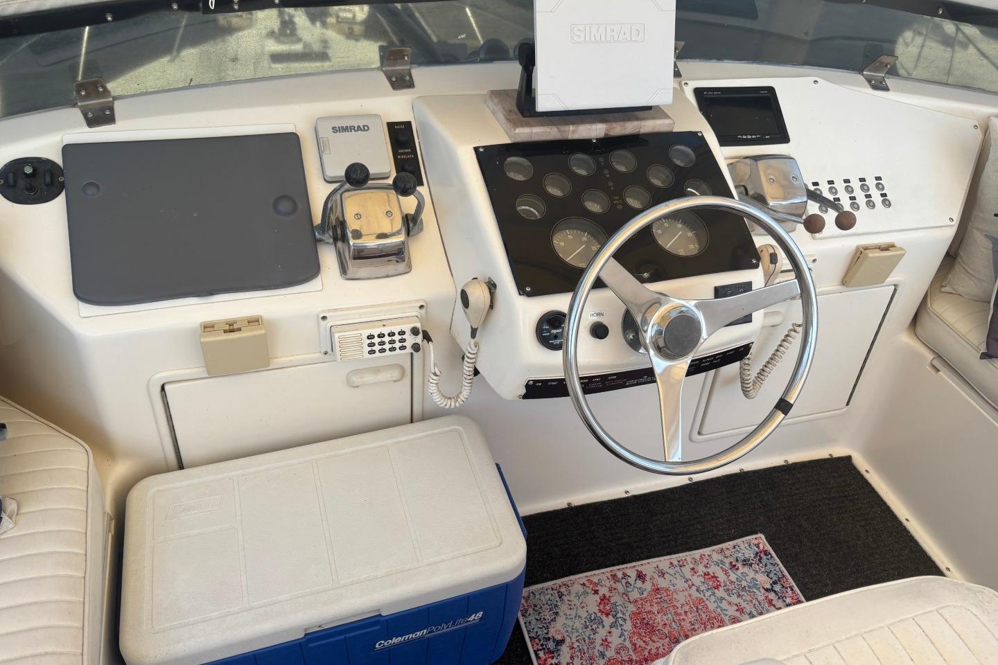 1993 Ocean Yachts 44 Aft Cabin helm with steering wheel and navigation equipment.