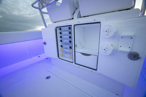 Manufacturer Provided Image: 2025 Southport 27 FE boat interior with storage compartments and ambient lighting.