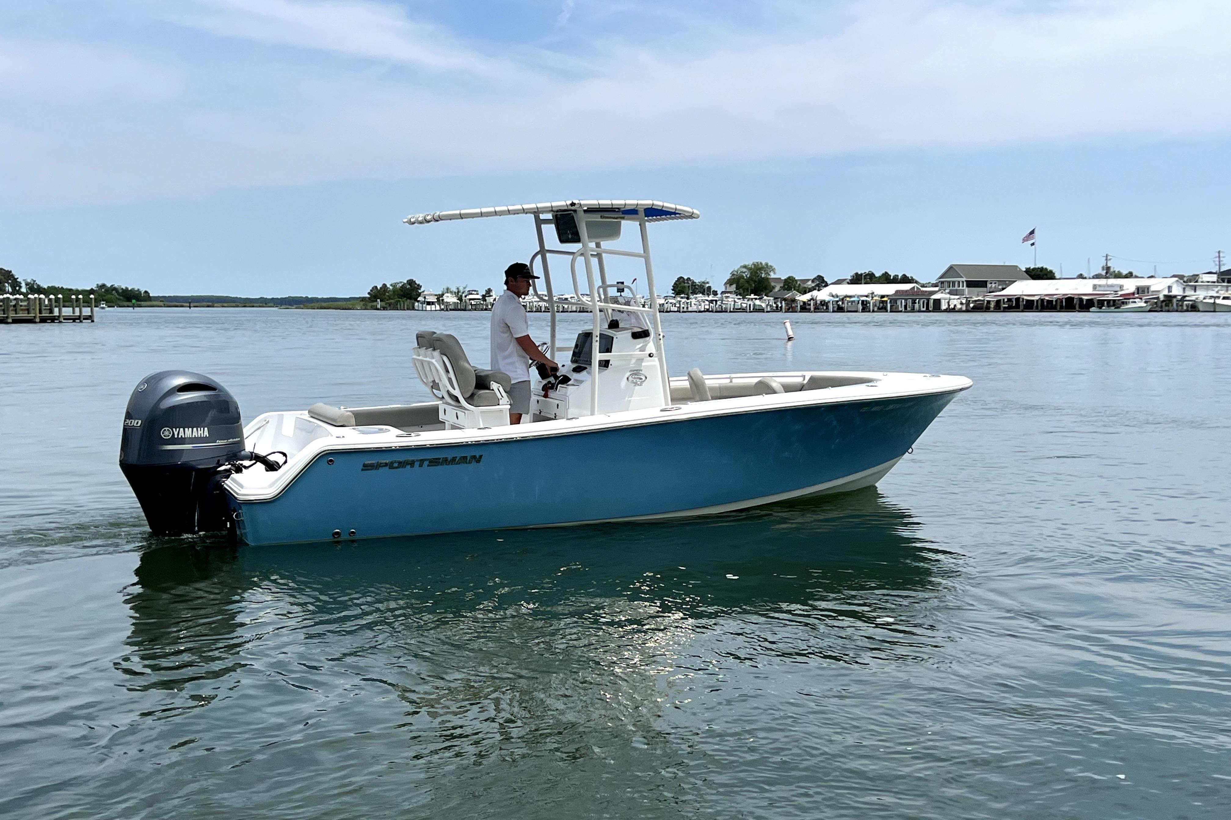 2022 Sportsman Open 212 Center Console boat on calm water, featuring a Yamaha outboard motor.