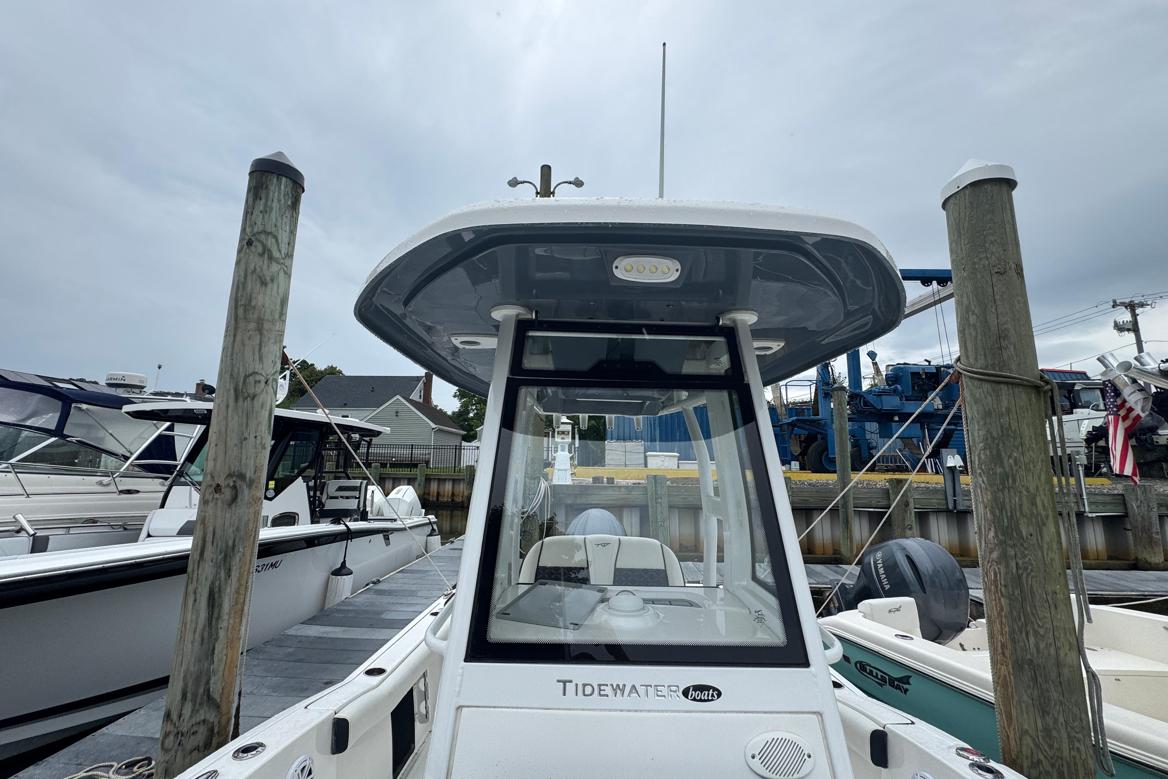 2022 Tidewater 232 SS boat docked at marina, showcasing sleek design and modern features.