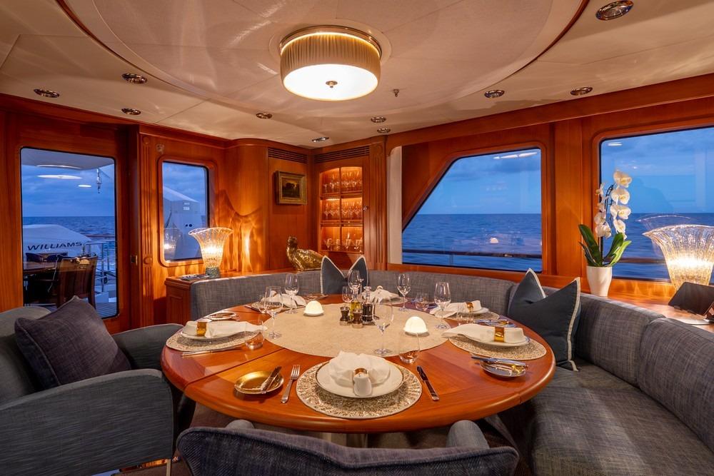 Luxurious dining area on 2002 Royal Hakvoort Canoe Stern yacht with ocean view.
