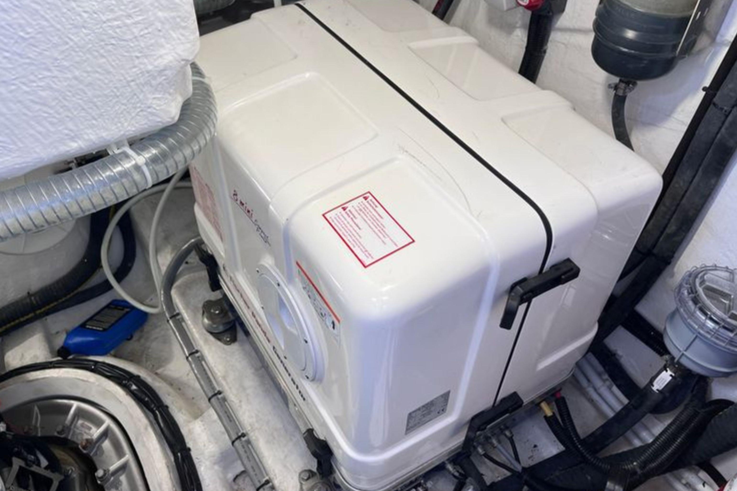 Engine room of 2024 Galeon 425 HTS yacht, featuring a white generator unit.