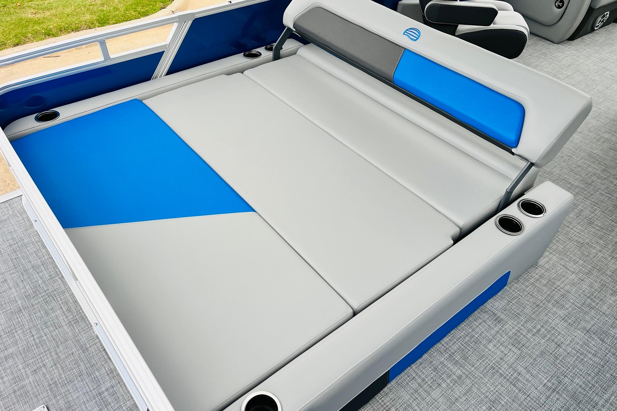 Sun Tracker Party Barge 22 RF DLX 2026 interior with blue and gray seating.