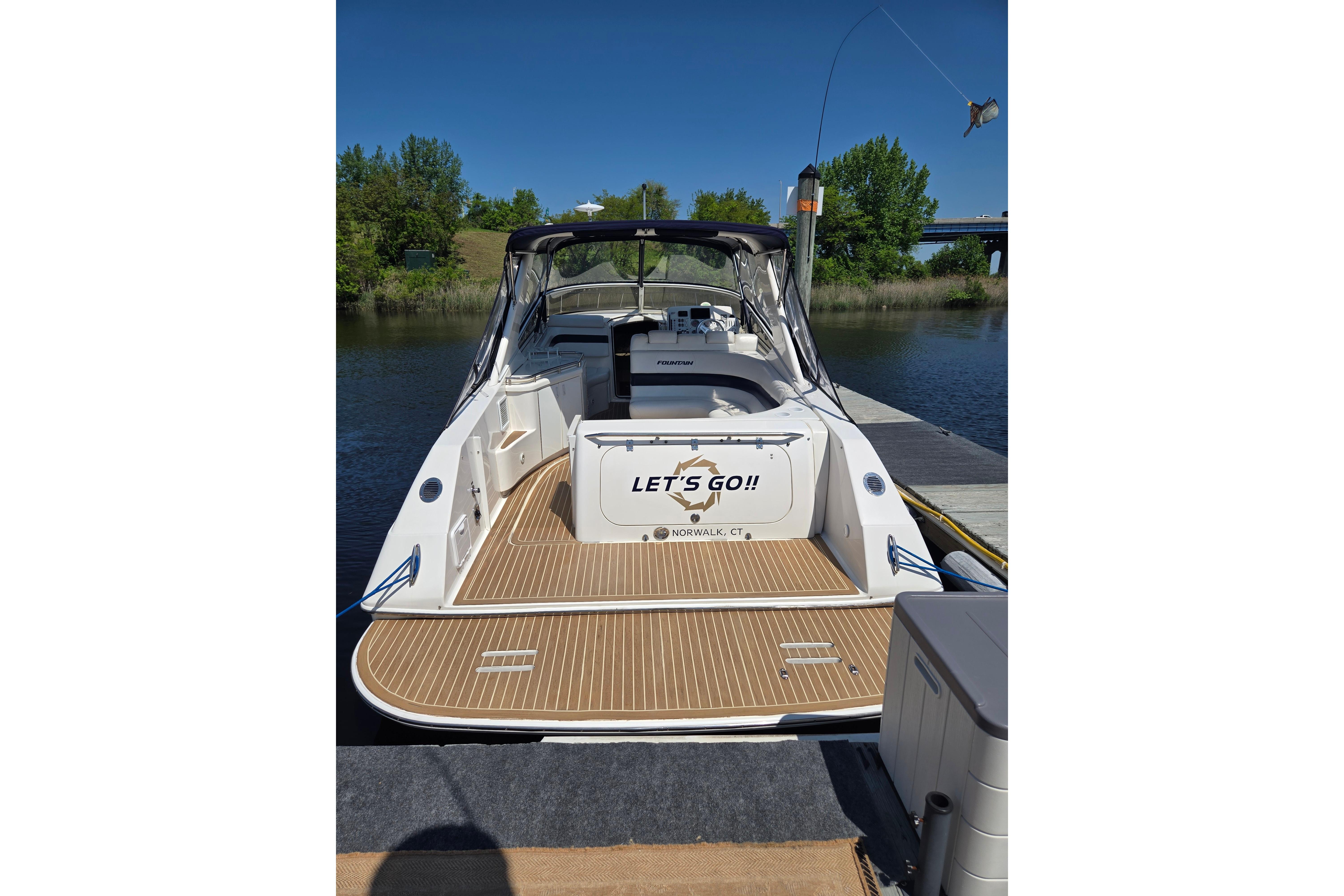 2007 Fountain 38 Express Cruiser docked by a serene river, ready for adventure.