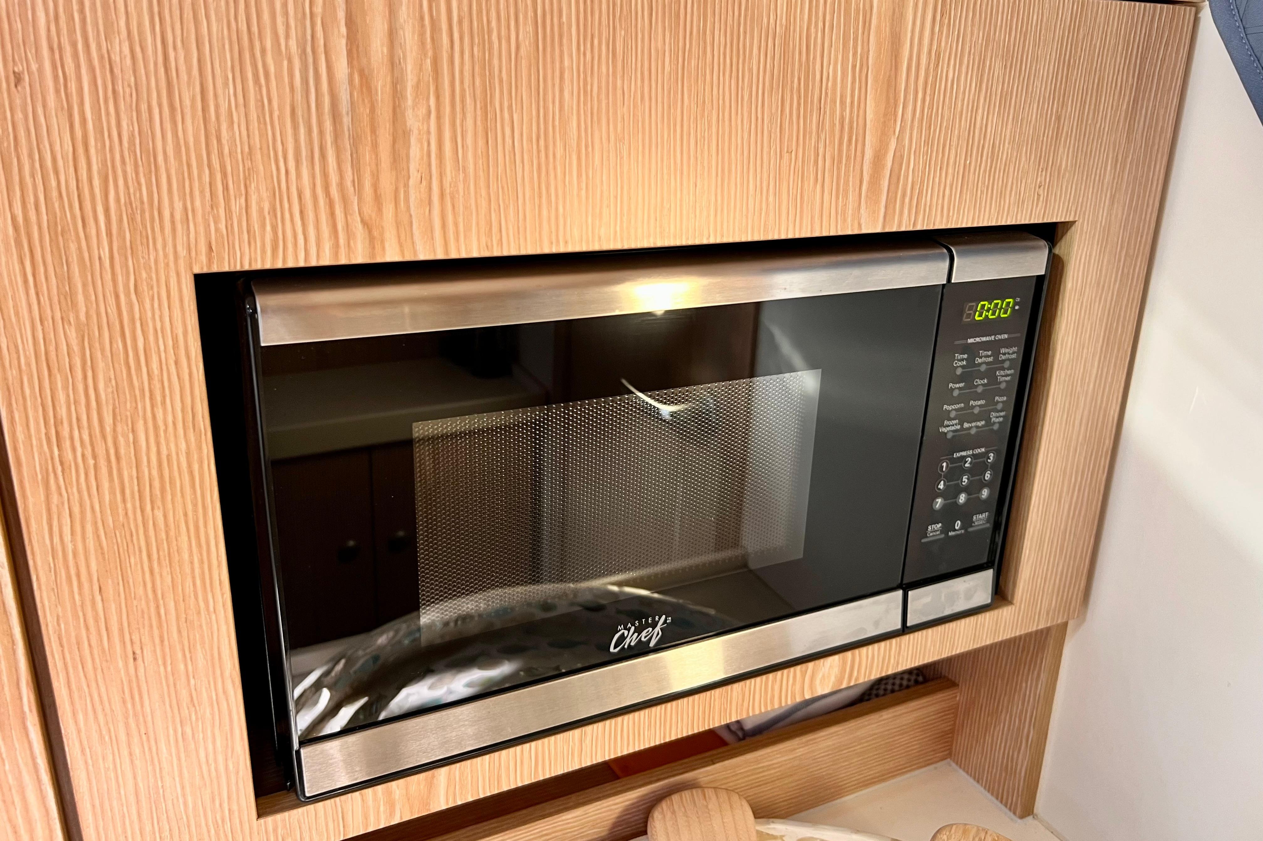 Built-in microwave in a 2016 Hanse 455 yacht kitchen, featuring a sleek stainless steel design.