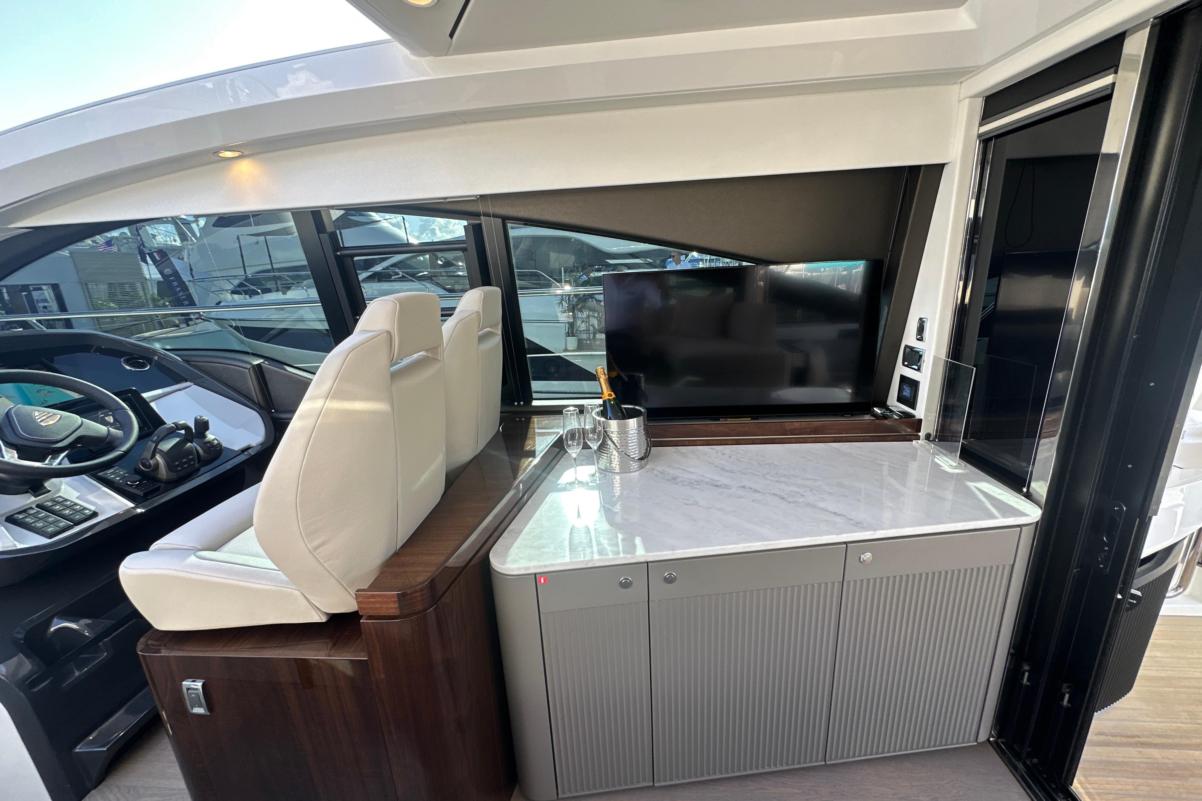 Interior of 2026 Fairline Targa 47 GT yacht with helm, seating, and entertainment area.