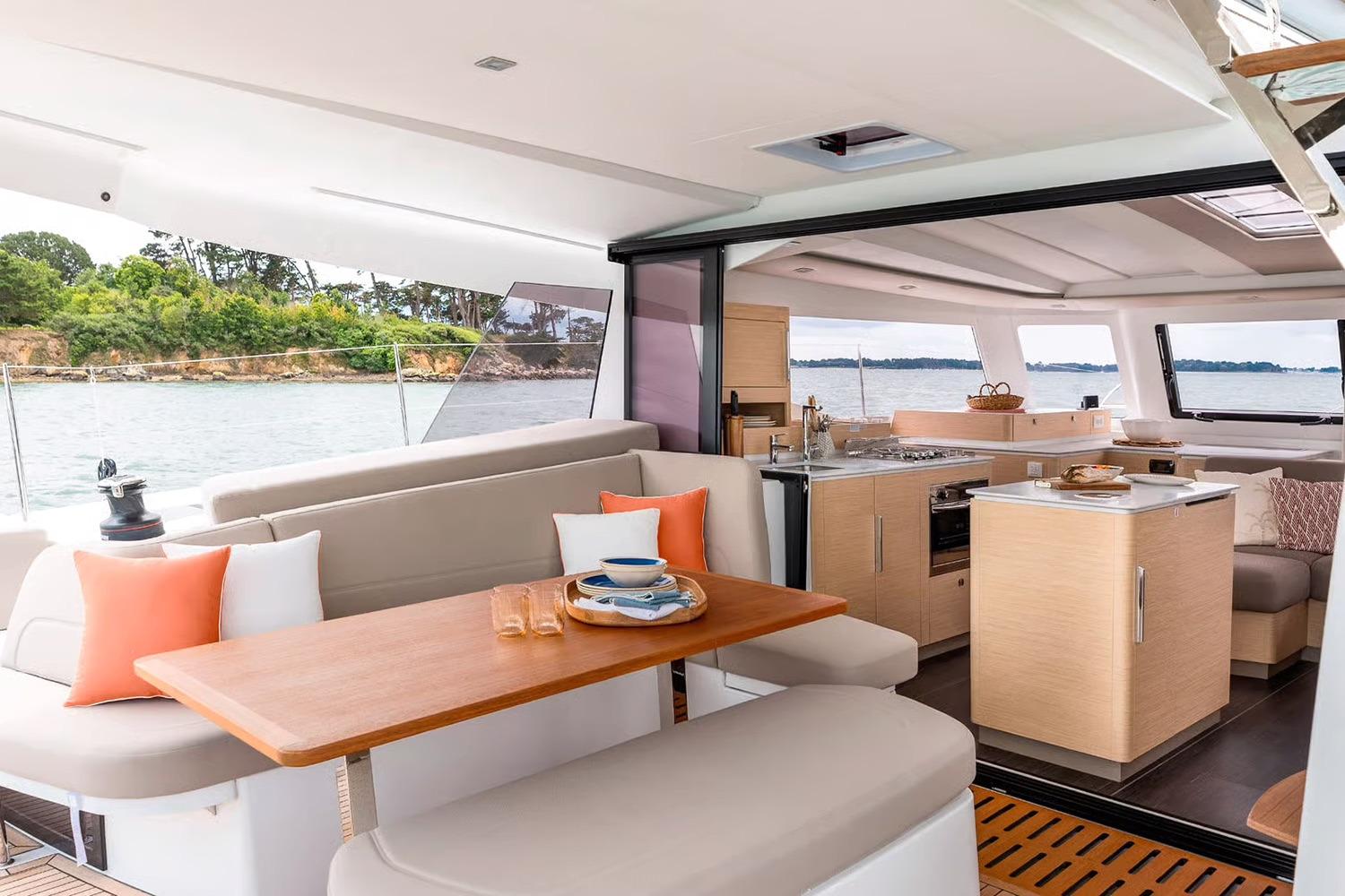 Manufacturer Provided Image: Luxurious interior of 2026 Fountaine Pajot FP41 Catamaran with modern kitchen and dining area.