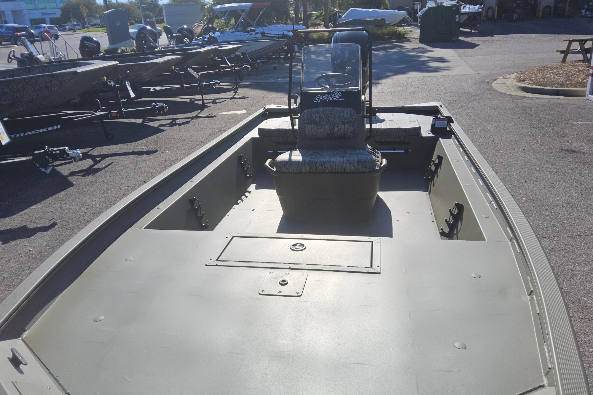 2026 Tracker Grizzly 1860 CC boat with center console, parked outdoors.