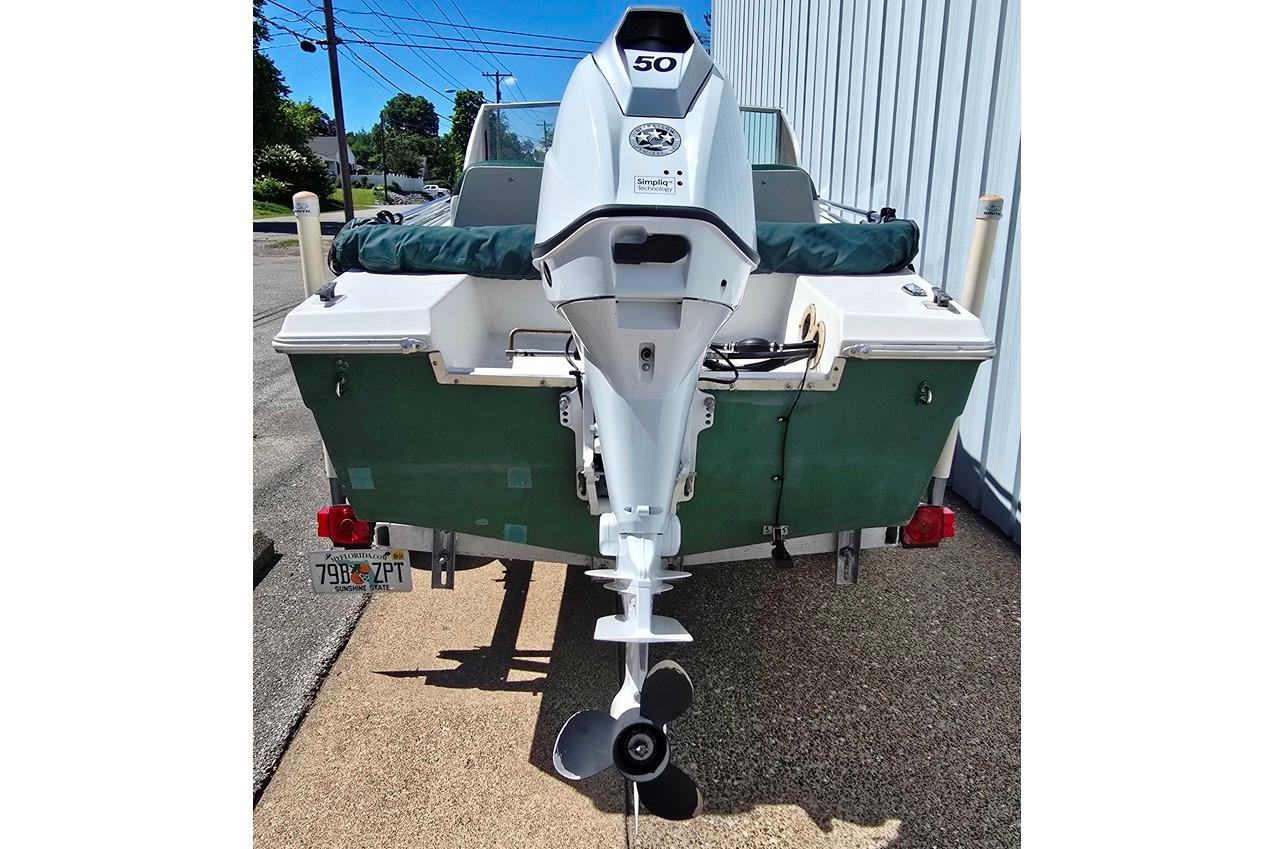 1971 Jupiter 15' Tri Hull boat with outboard motor, parked on a trailer.