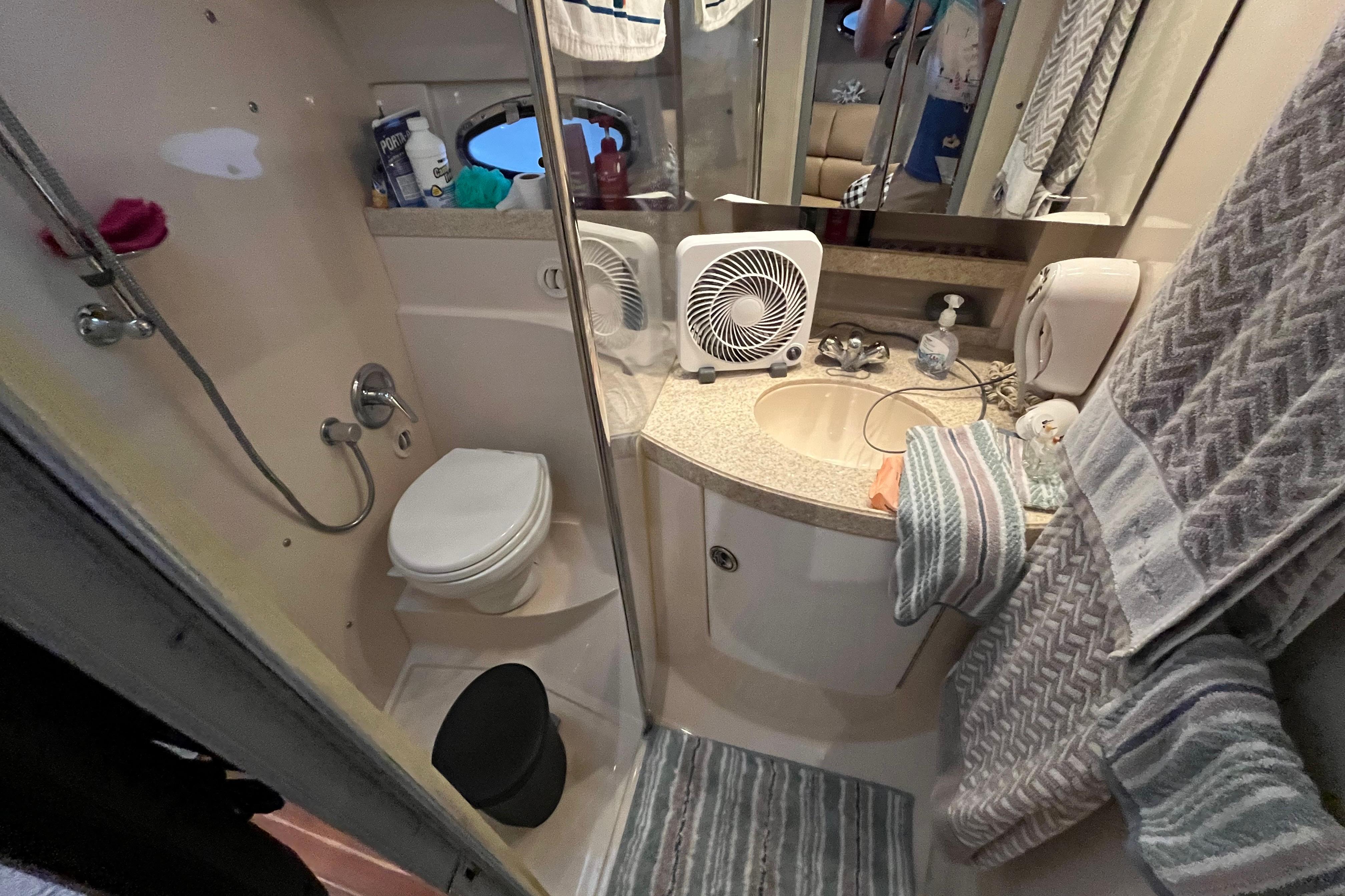 Bathroom interior of 2007 Regal 3760 IB Commodore yacht, featuring shower, toilet, and sink.