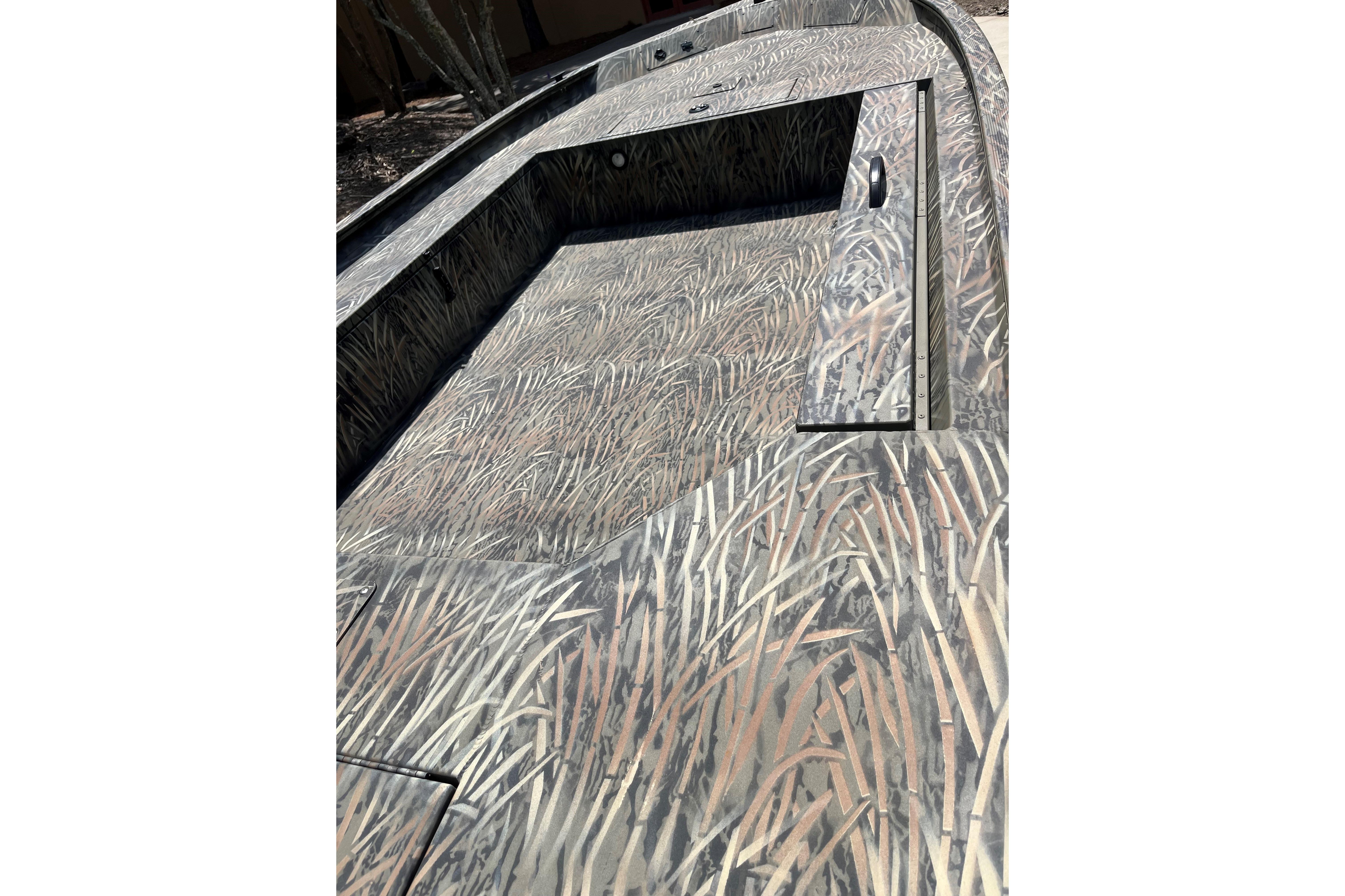 2026 Tracker Grizzly 1654 T Sportsman boat with camouflage pattern interior design.