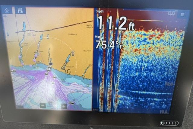 Boat navigation display showing depth of 11.2 feet and water temperature of 75.4°F.