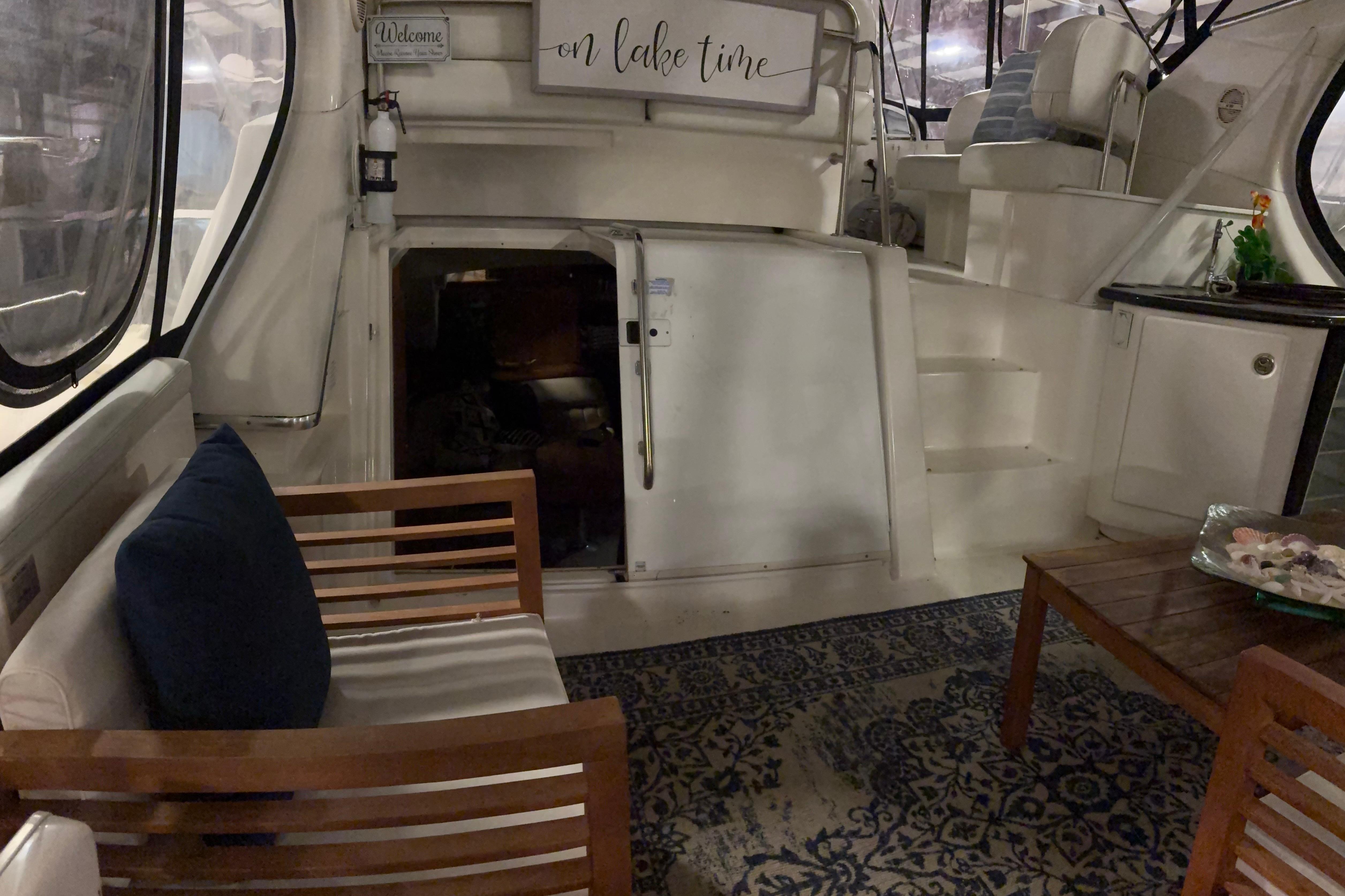 Interior of 2003 Silverton 43 Motor Yacht with cozy seating and nautical decor.
