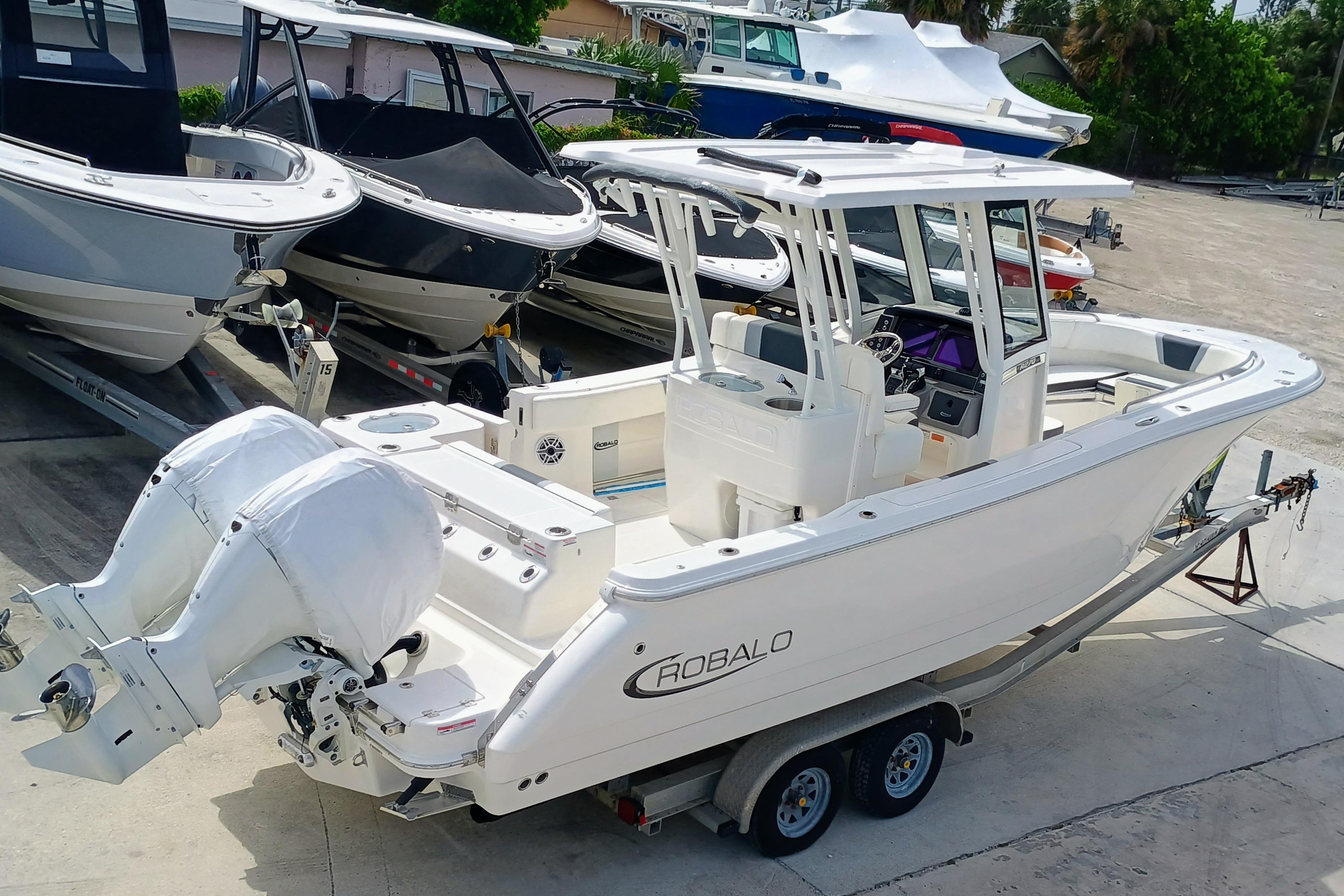 2025 Robalo R270 Center Console boat on trailer, featuring dual engines.