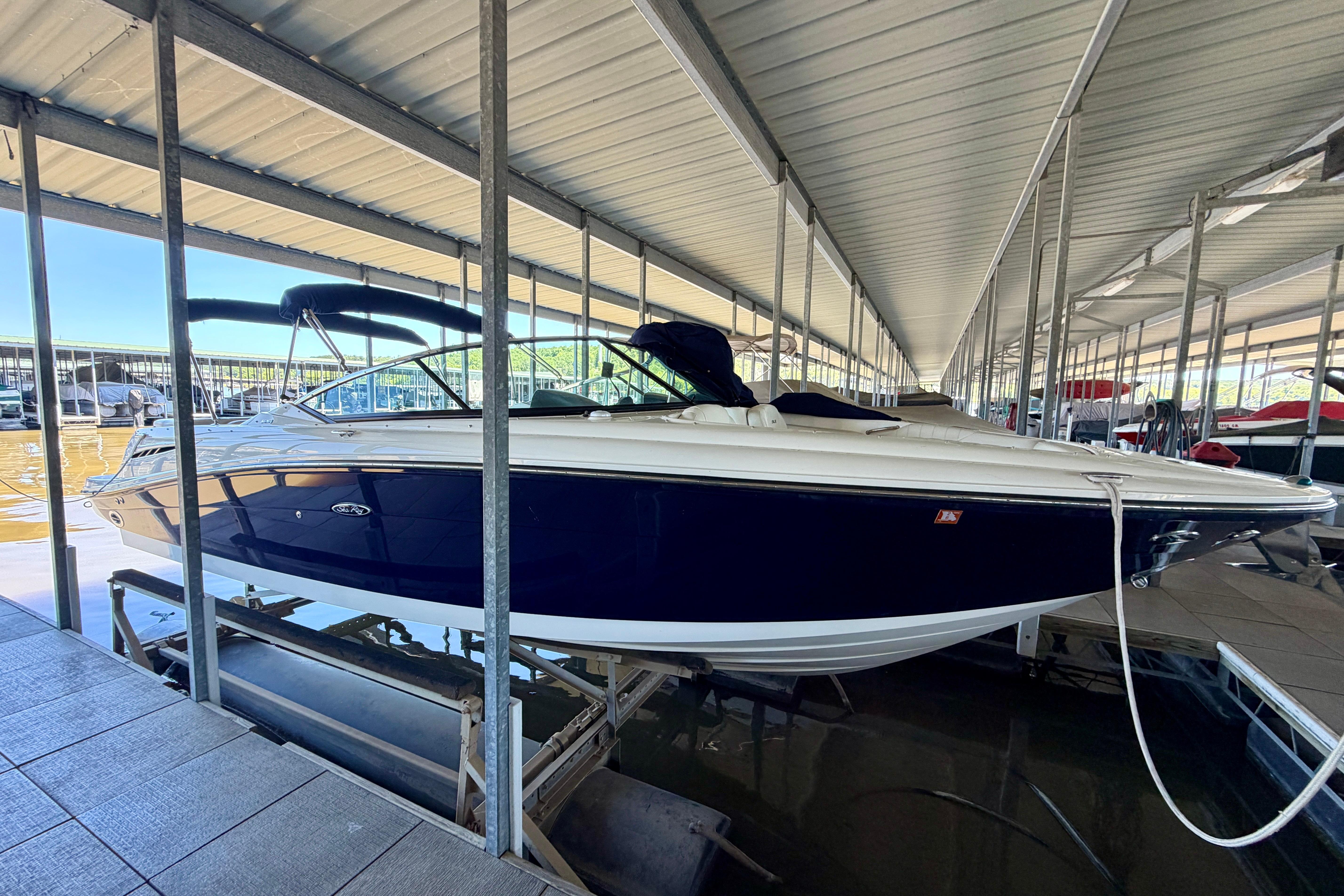 2007 Sea Ray 270 SLX boat docked in a covered marina.