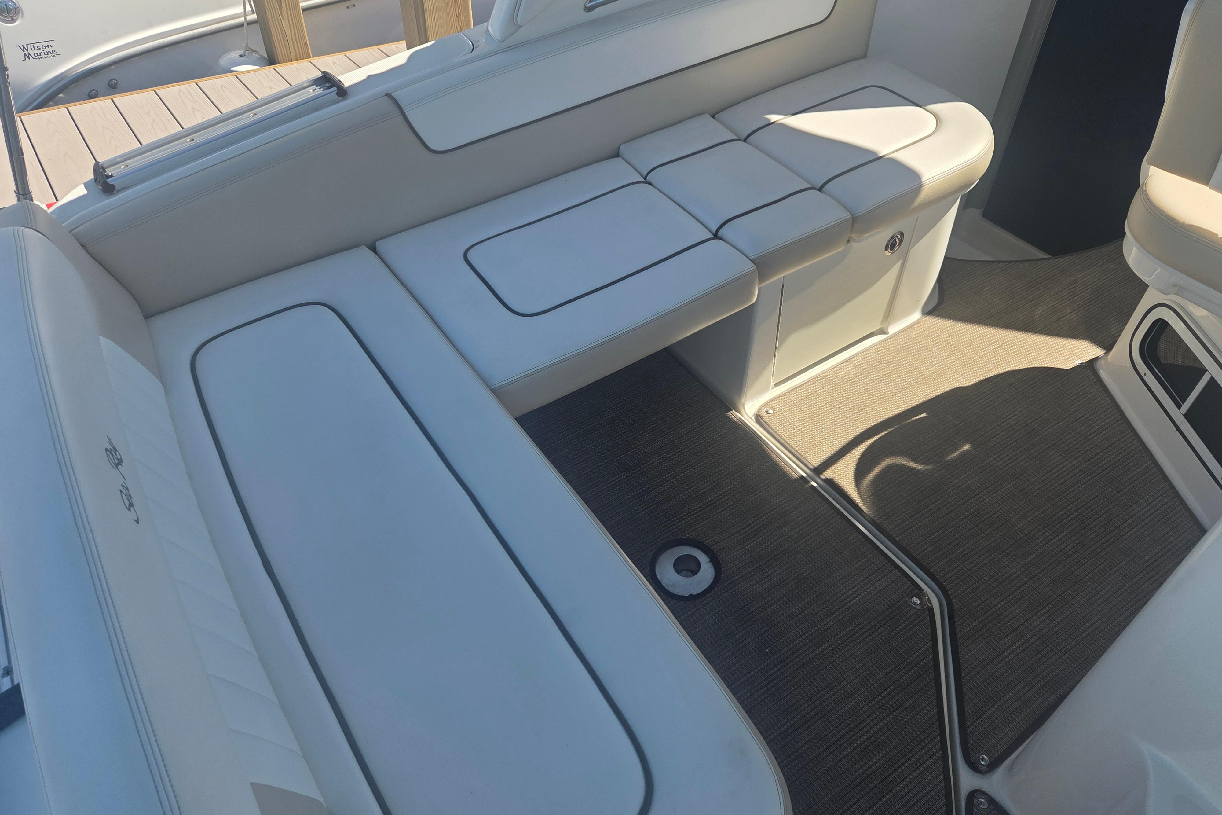 Interior seating of 2012 Sea Ray Sundancer 260 boat with white upholstery.