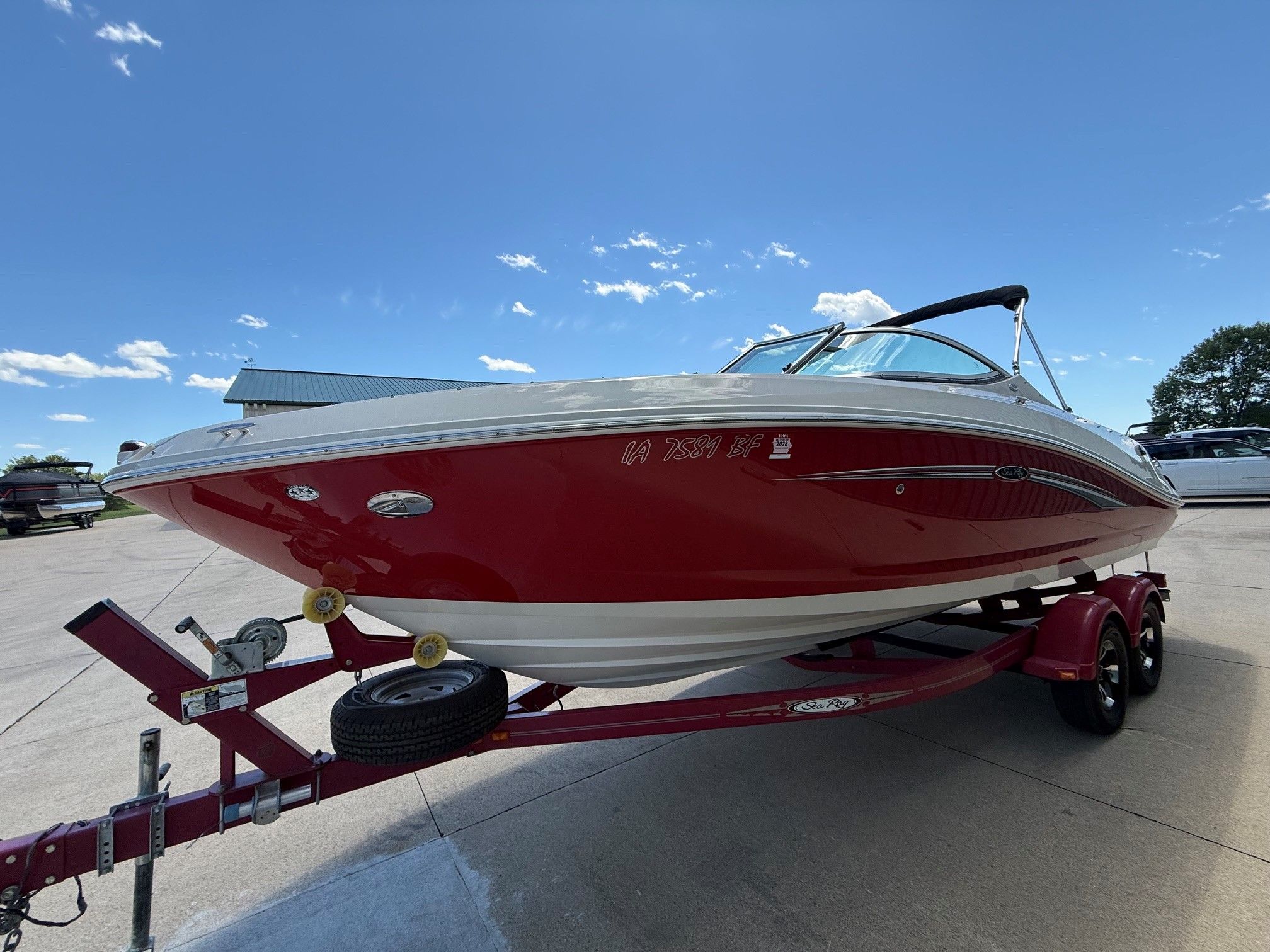 2007 Sea Ray 230 Select boat on trailer, blue sky.