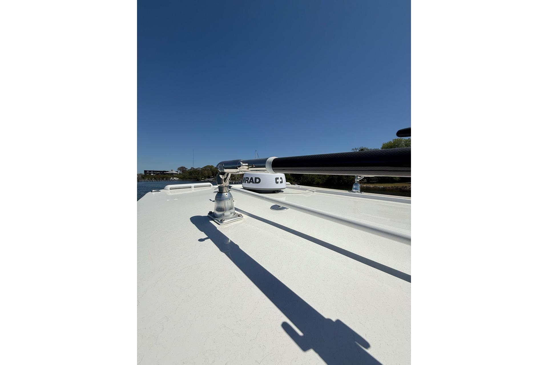 2021 Custom Infusion 34 CC boat deck with radar equipment under clear blue sky.