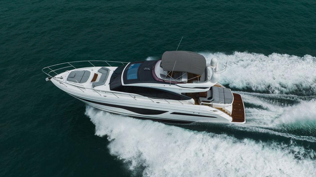 2022 Princess S66 yacht cruising on open water, aerial view.