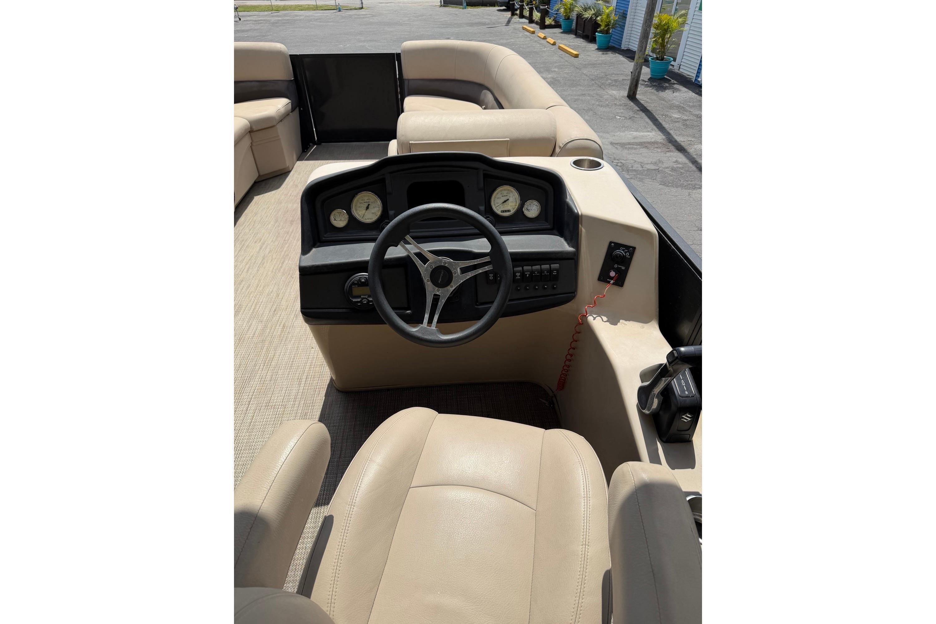 2022 Bentley Pontoons 240 CRUISE interior with beige seating and steering console.