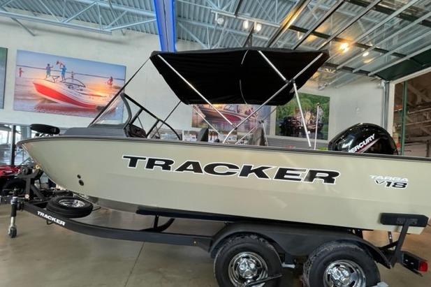 2026 Tracker Targa V-18 WT boat displayed indoors with canopy and trailer.