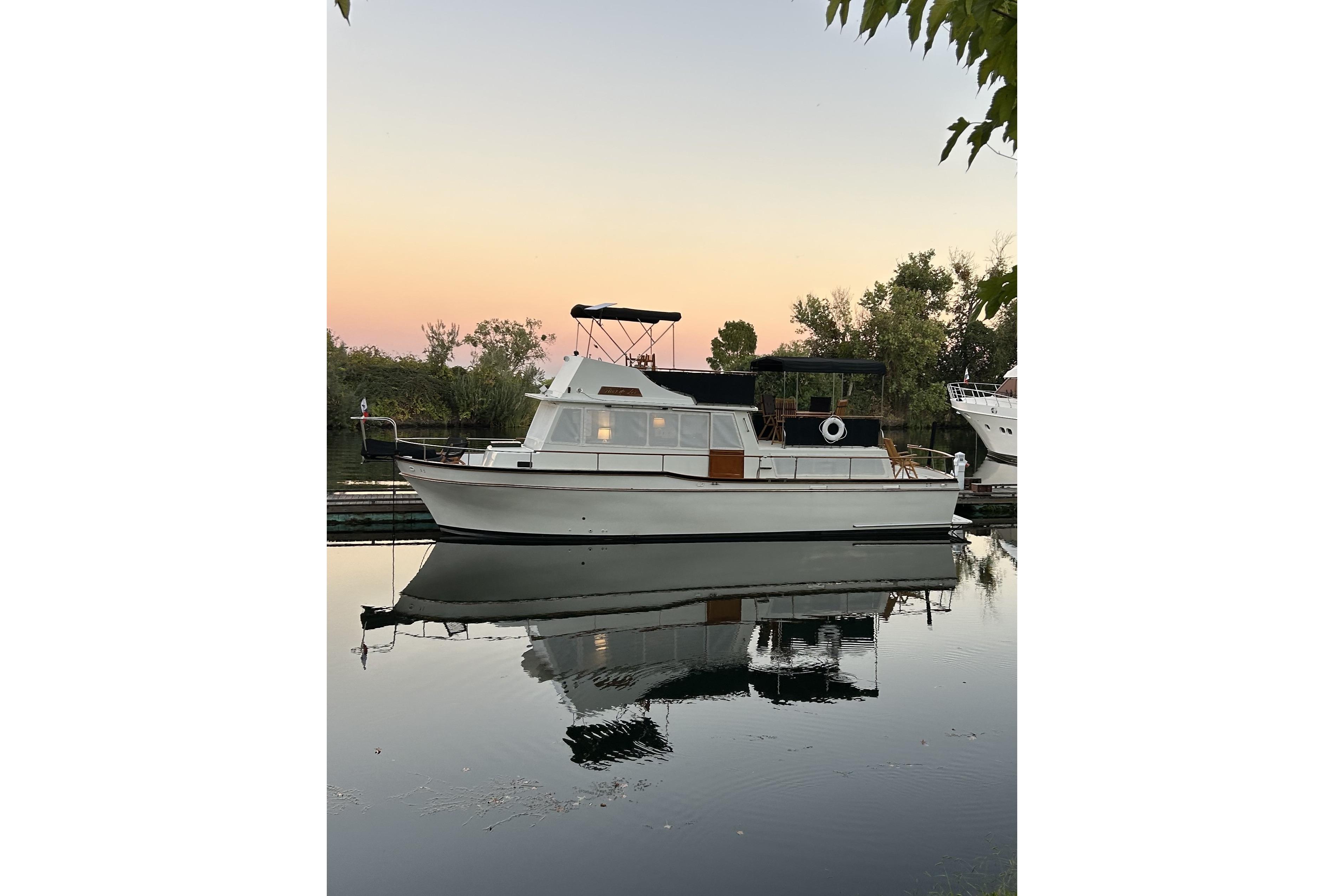 1978 Californian 42 LRC yacht docked at sunset, reflecting on calm water.