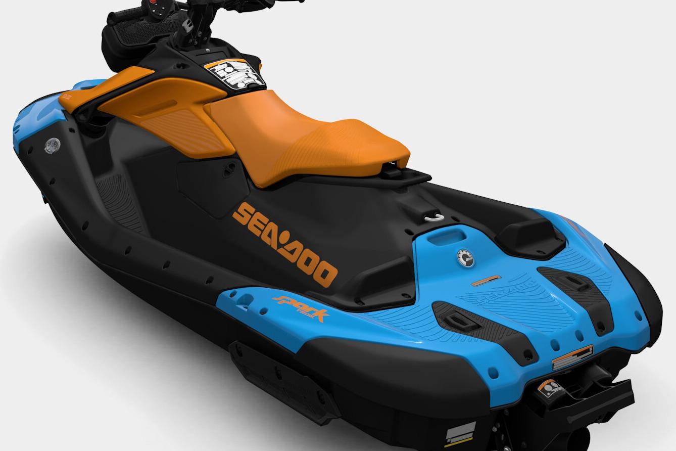 2026 Sea-Doo Spark Trixx jet ski, black and blue design with orange seat.