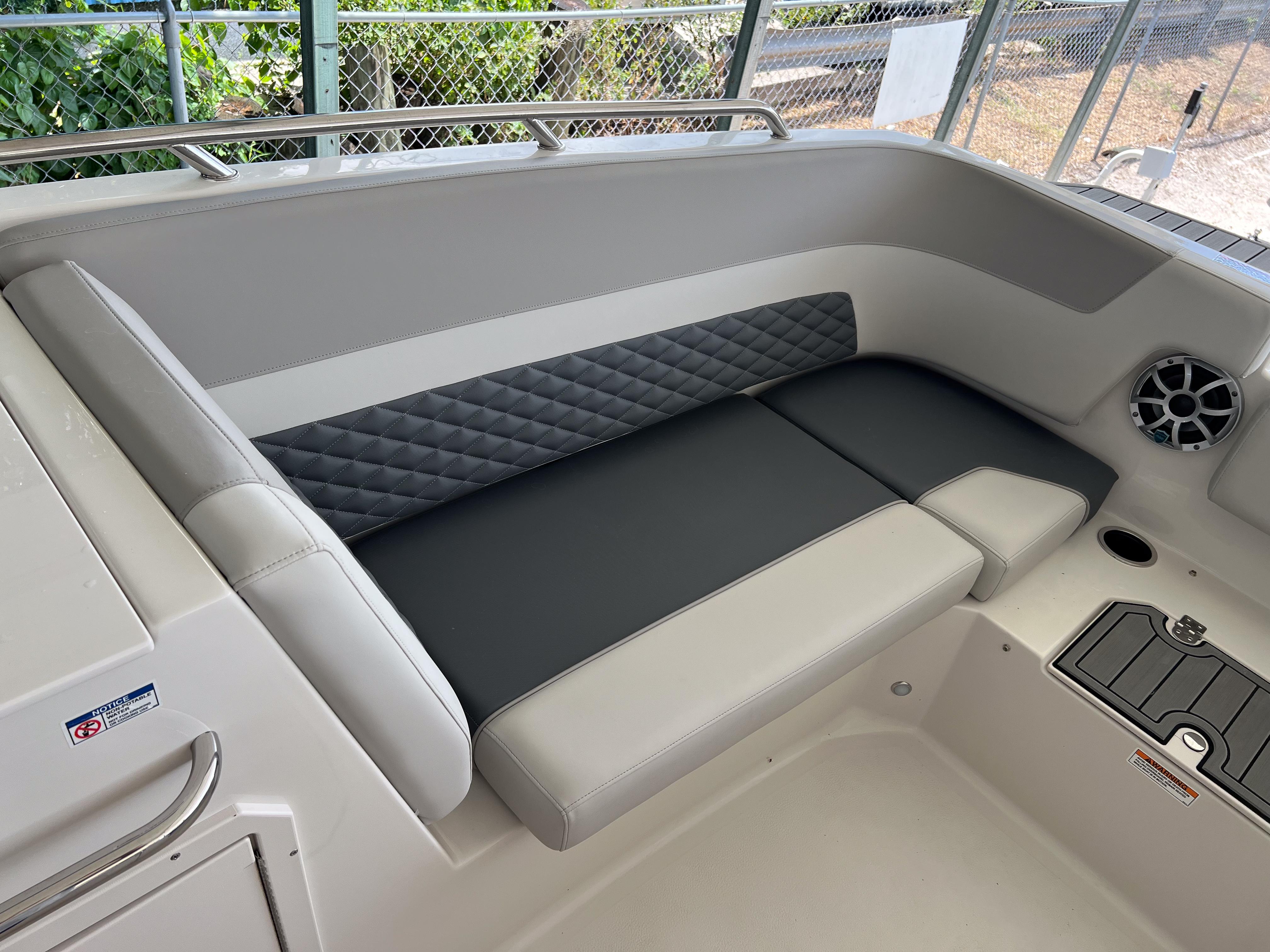 2026 Starcraft SVX 231 OB boat interior with cushioned seating and speaker.