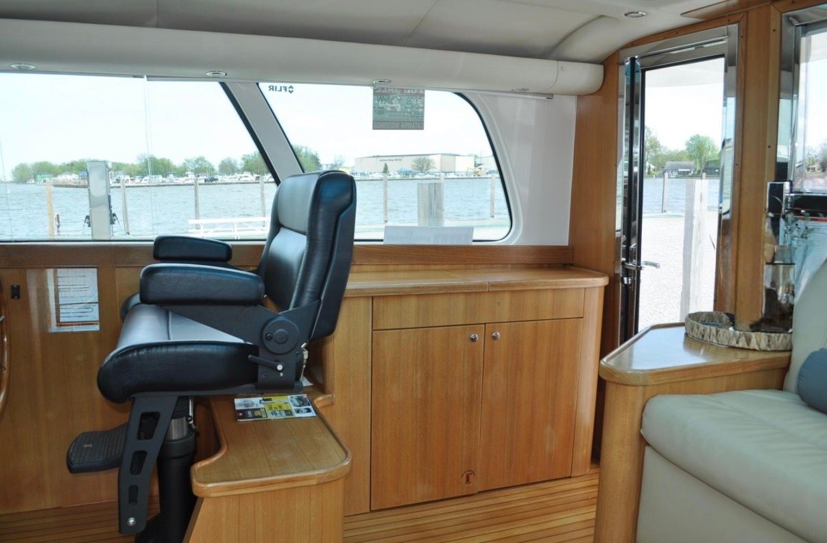 Interior of a 2005 Tiara Yachts 5200 Sovran with wood furnishings and leather seating.
