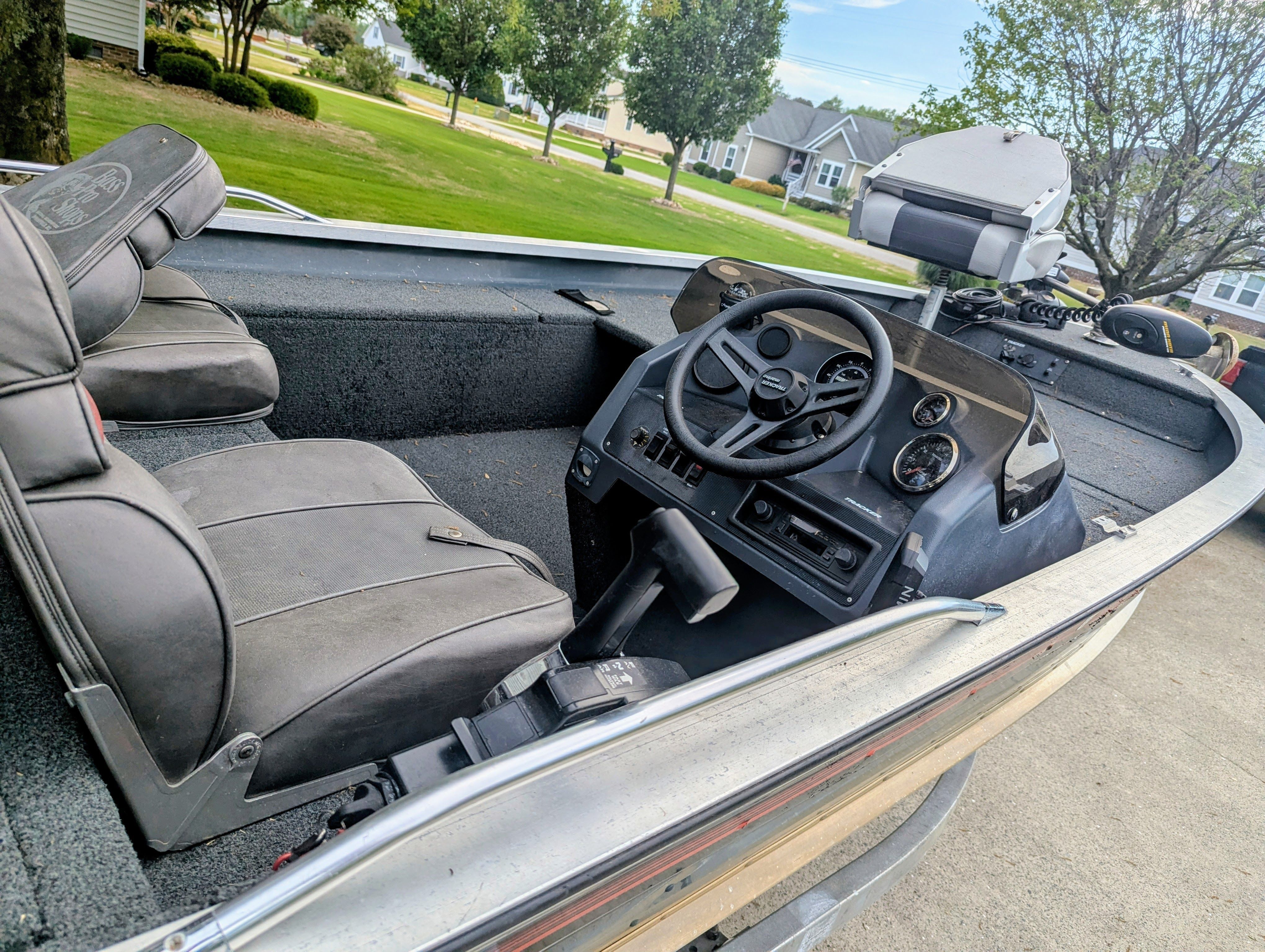 Interior view of a 1988 Bass Tracker Tournament V with steering wheel and seats.