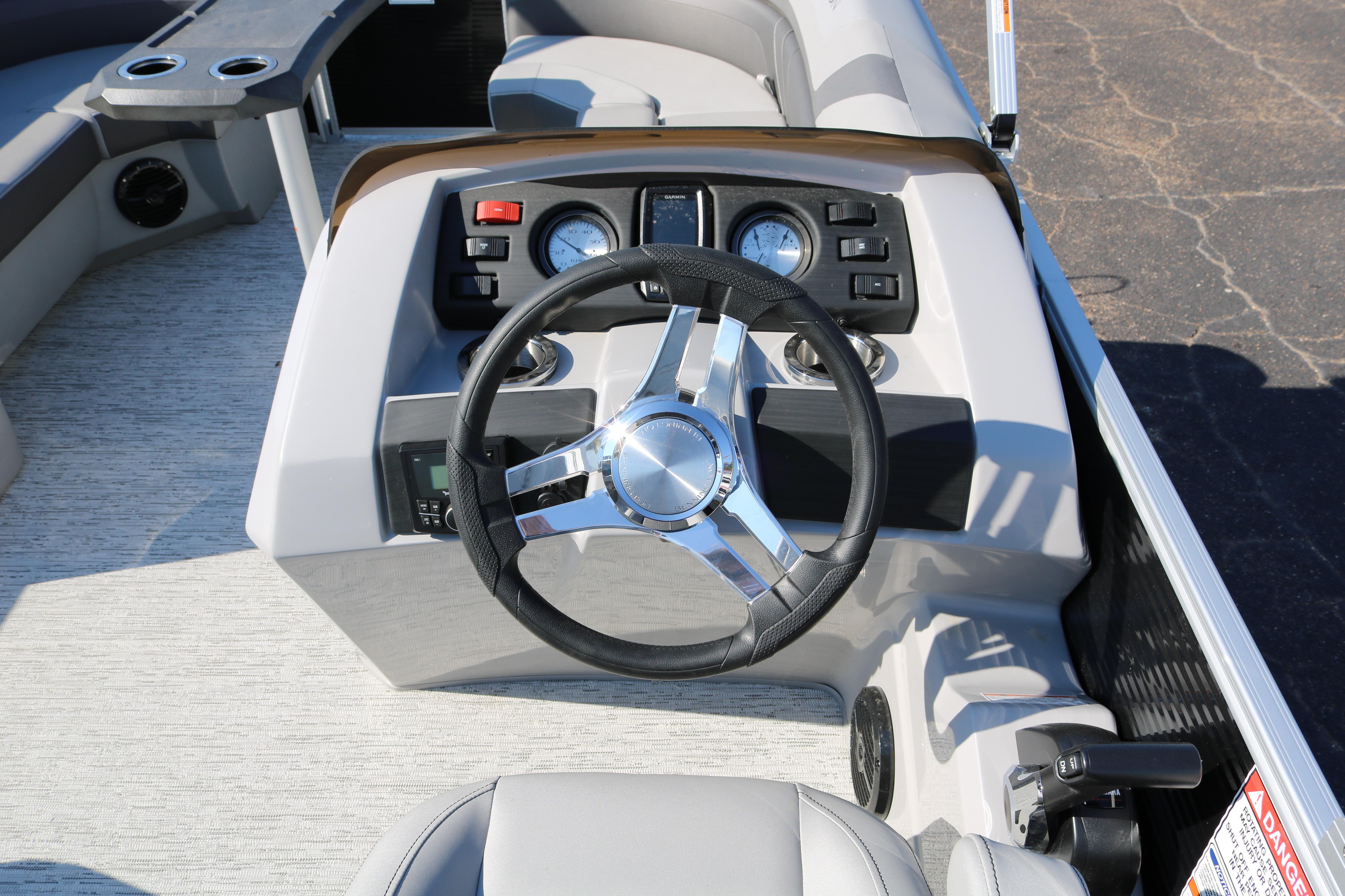 2026 Bennington 22SX Stern Radius boat dashboard with steering wheel and controls.