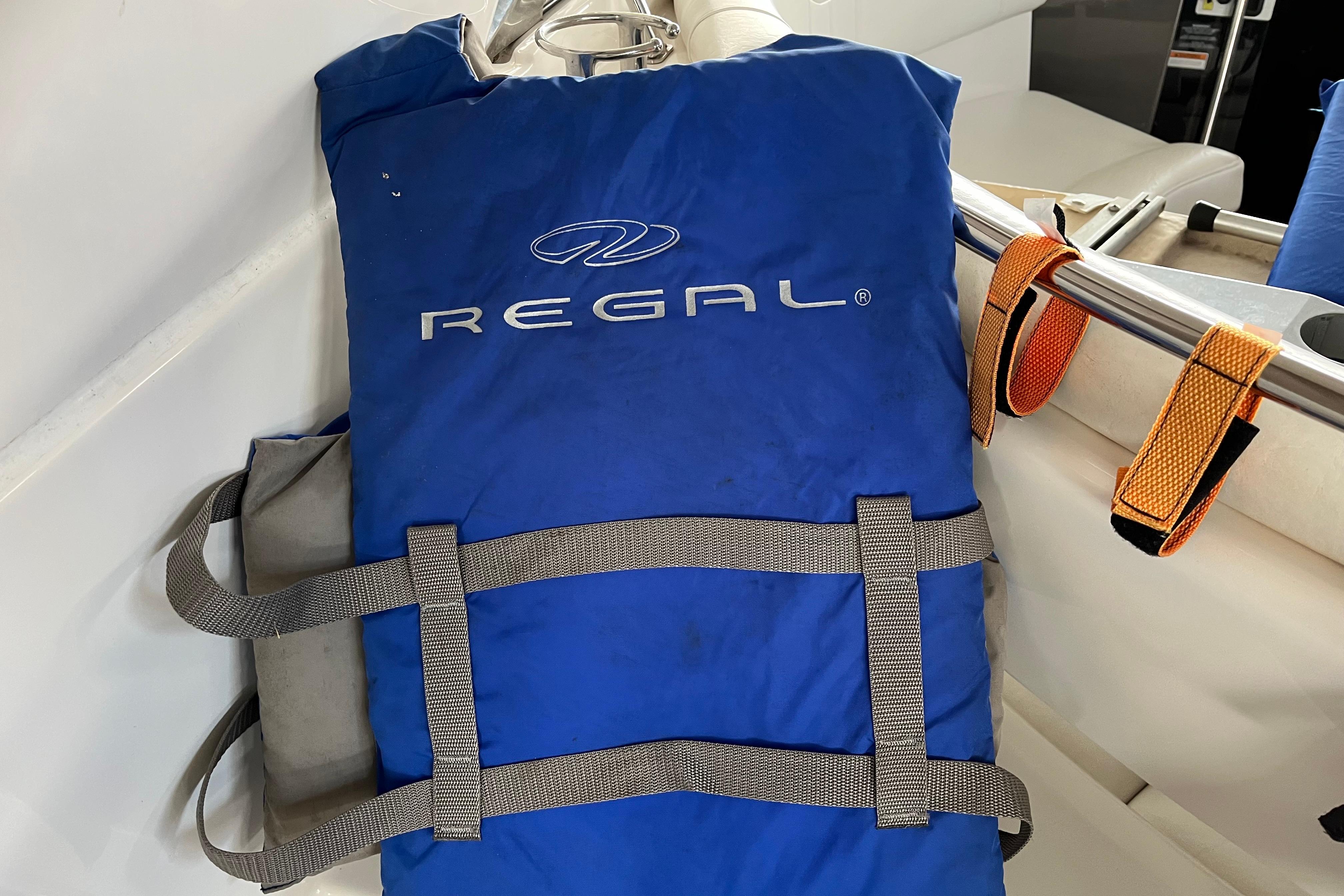 Blue Regal life jacket on a 2007 Regal 3760 IB Commodore boat.