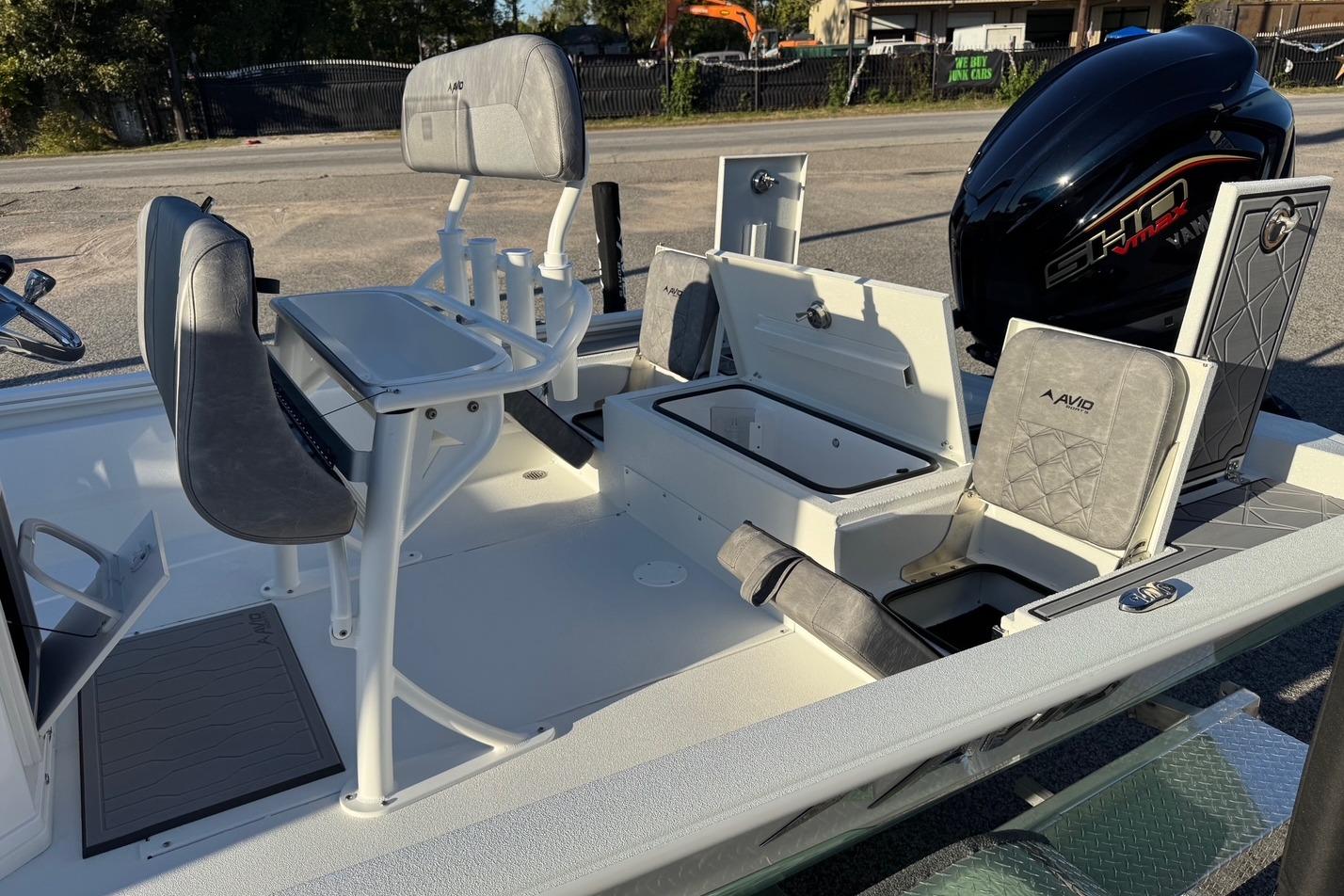 2025 Avid 23 Mag boat interior with seating and storage compartments.