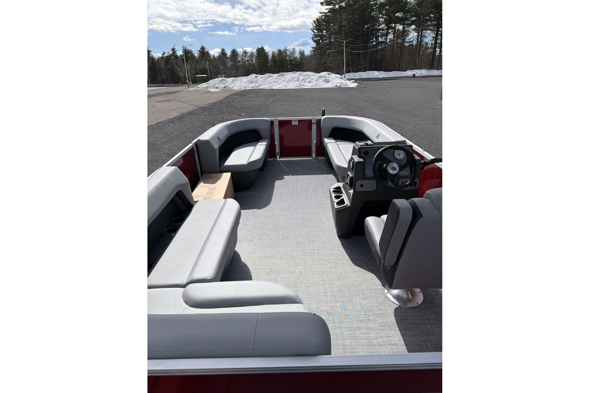 2026 Sun Tracker Party Barge 16 DLX interior with seating and steering console.