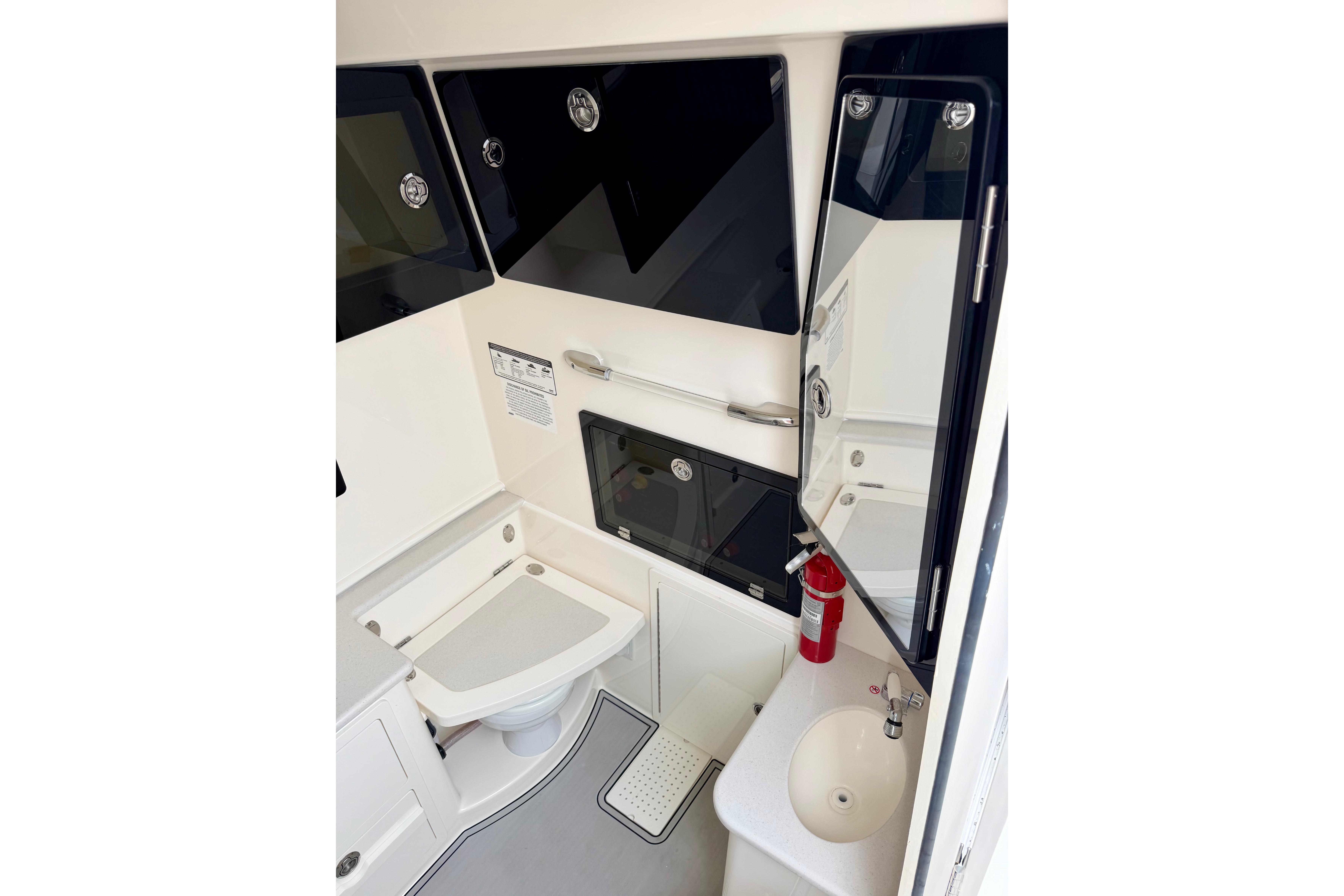 2023 Cobia 350 Center Console boat interior with toilet, sink, and fire extinguisher.