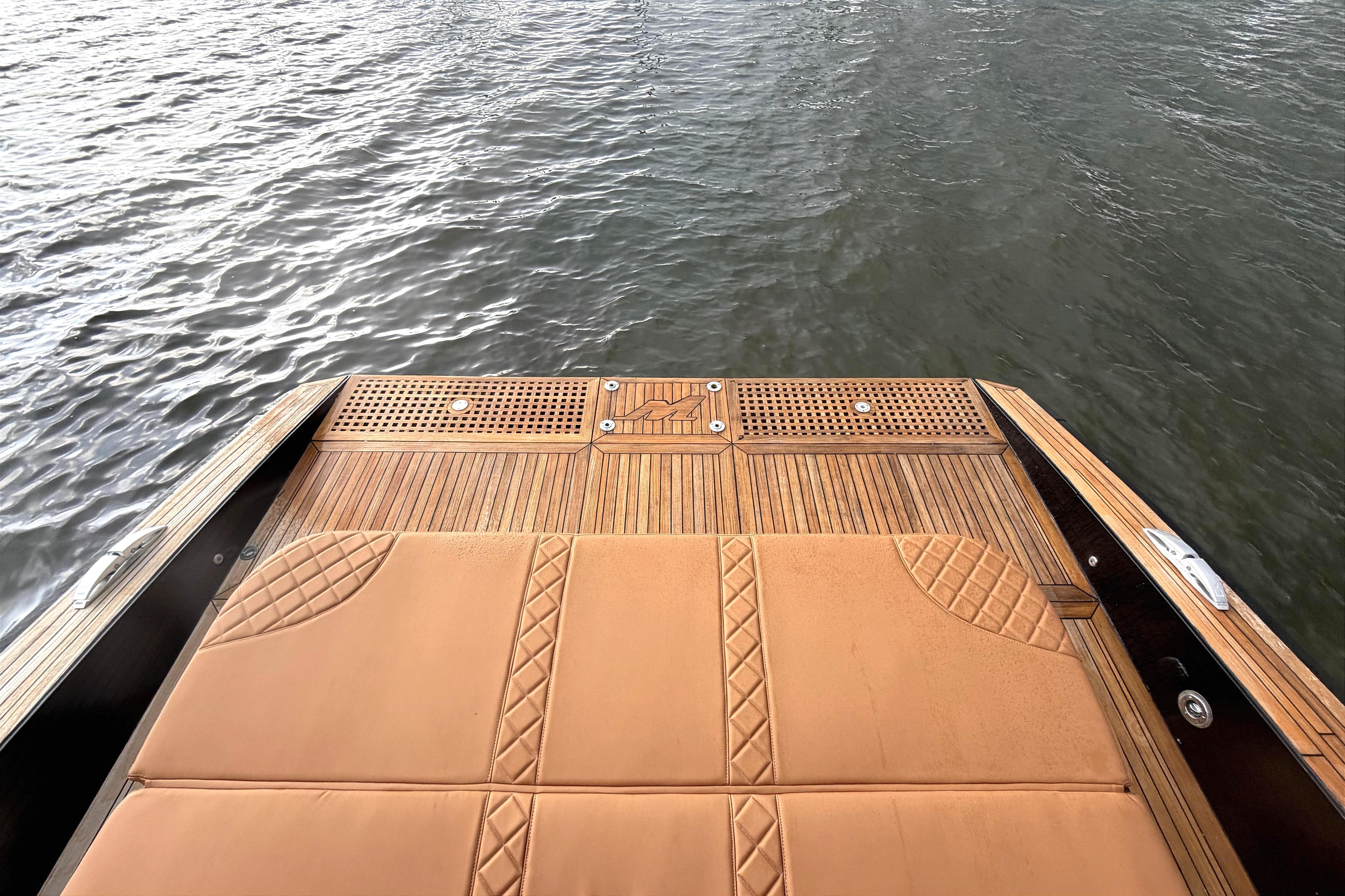 Luxury teak deck of 2013 Windy SR52 yacht overlooking water.